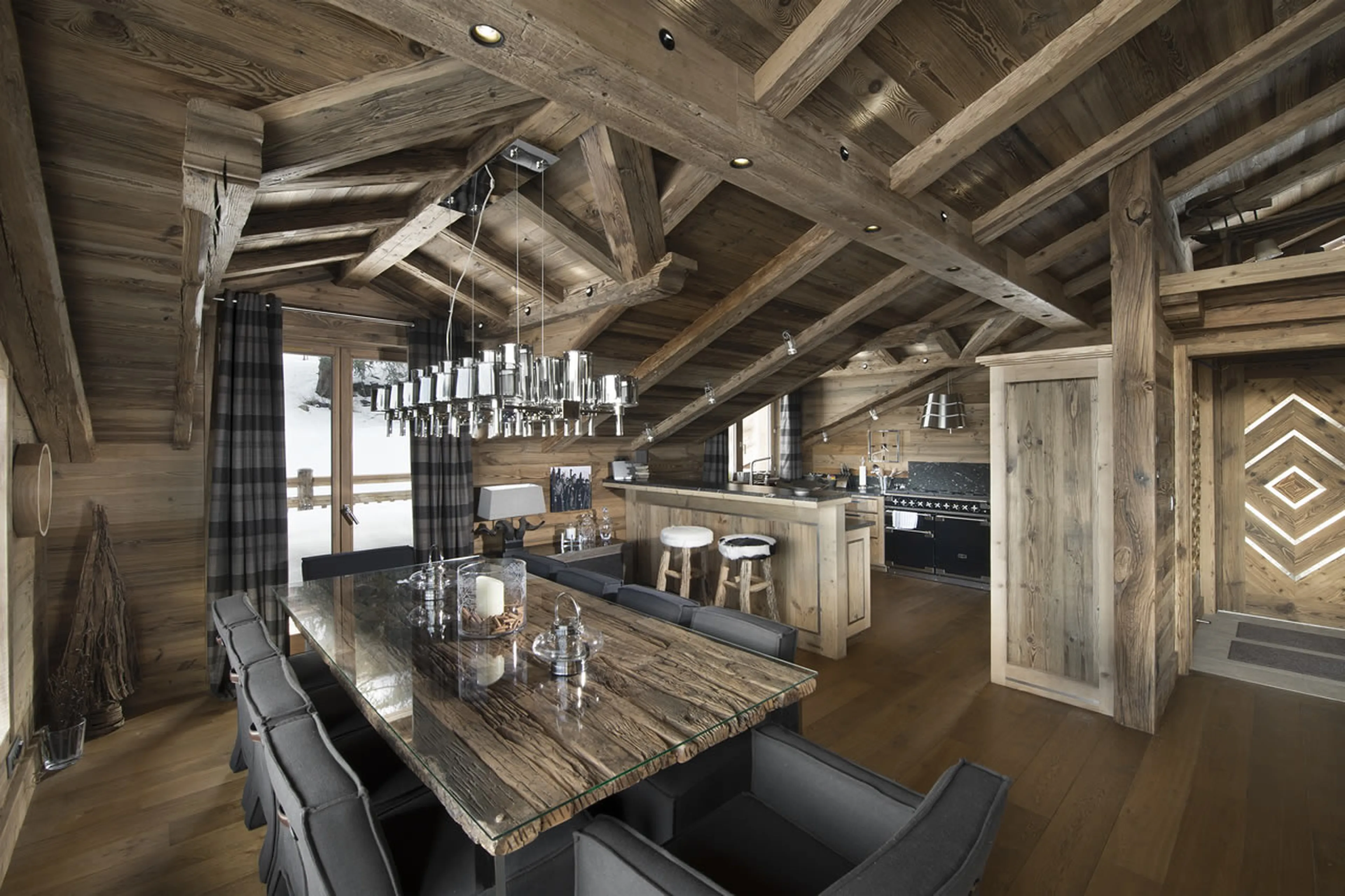 Dining area next to open plan kitchen in Chalet M in Courchevel 1550