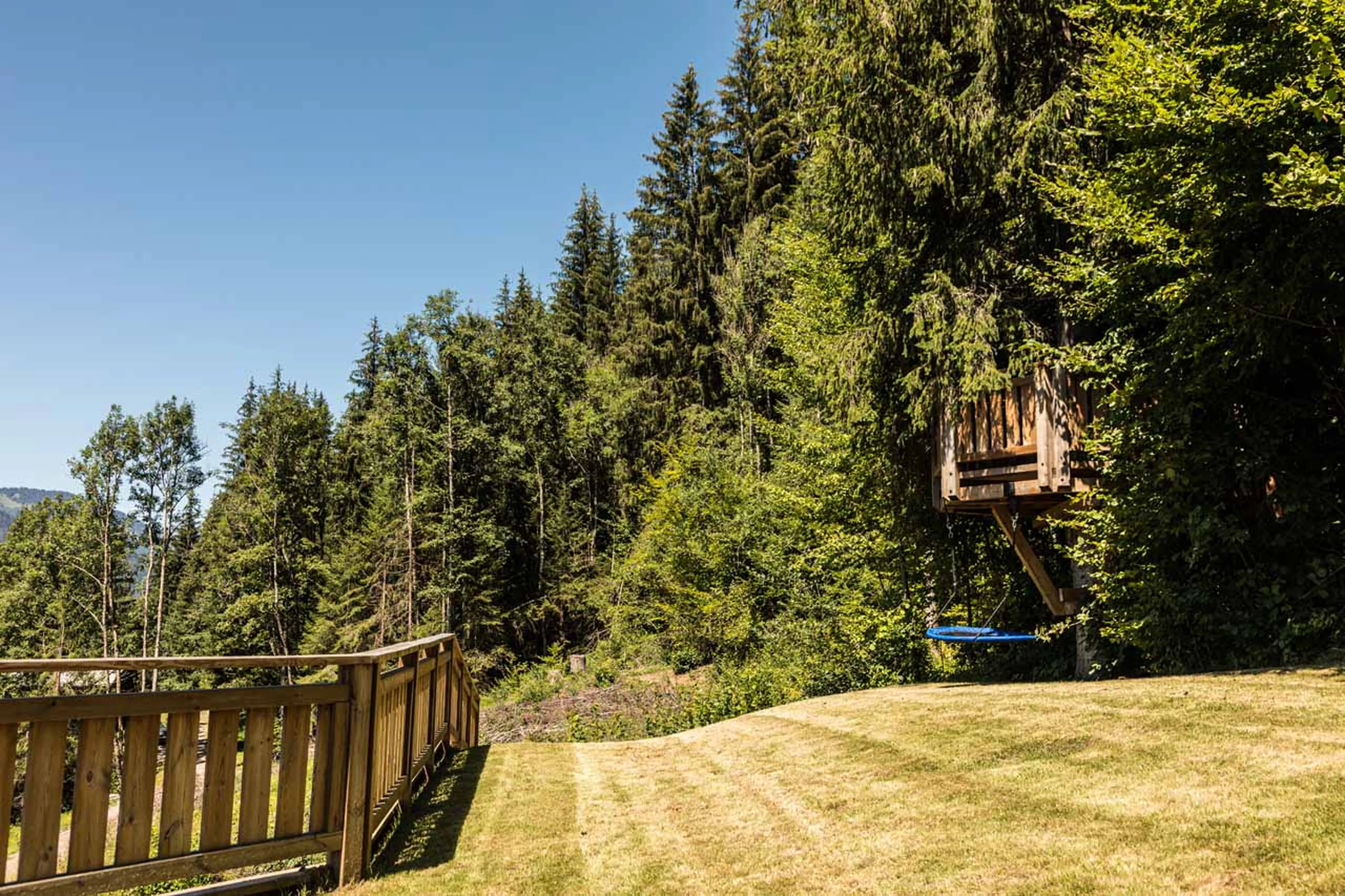 Garden with trampoline at Chalet M in Morzine in summer