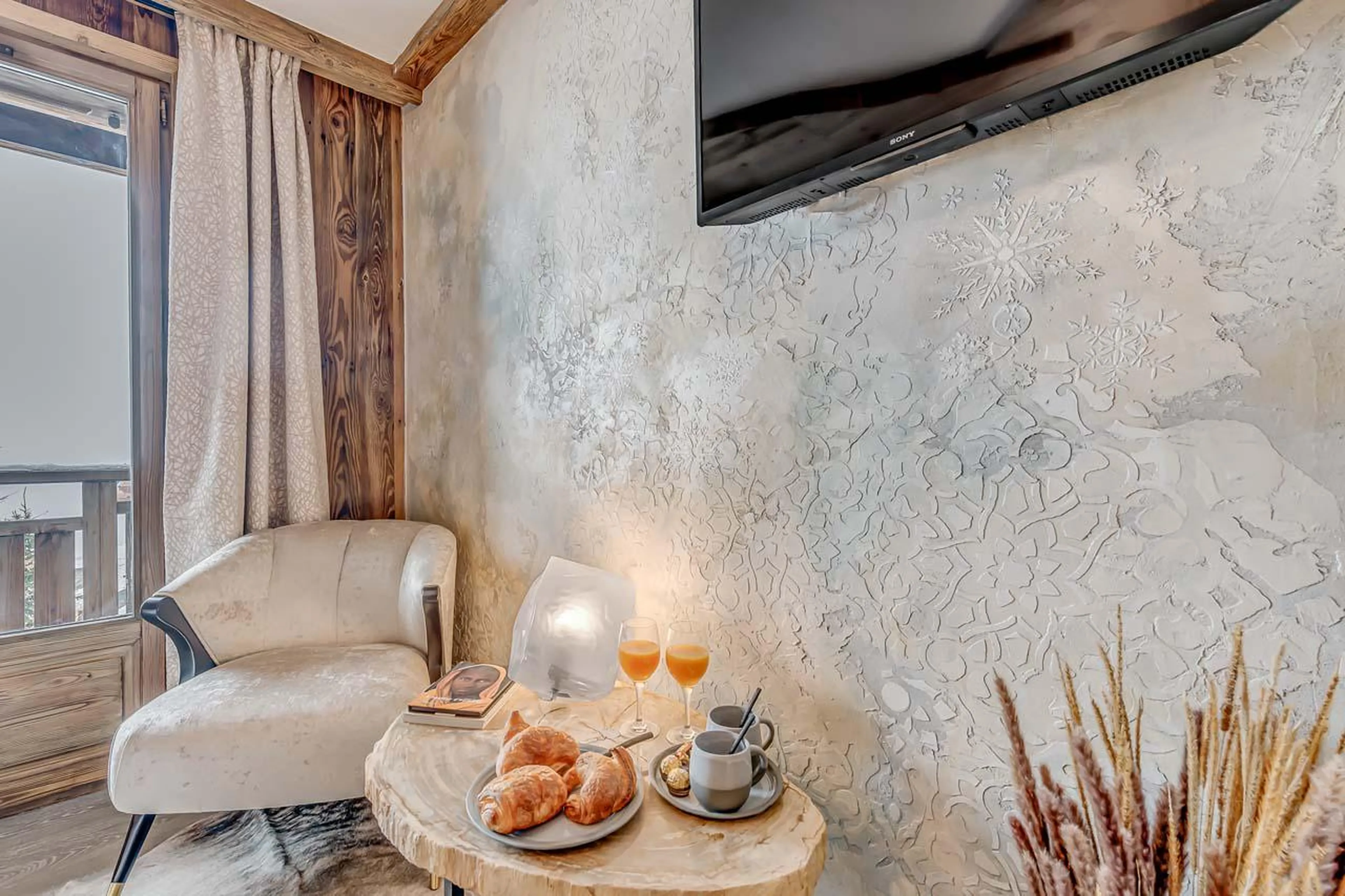 TV and French window at Chalet Macha in Tignes