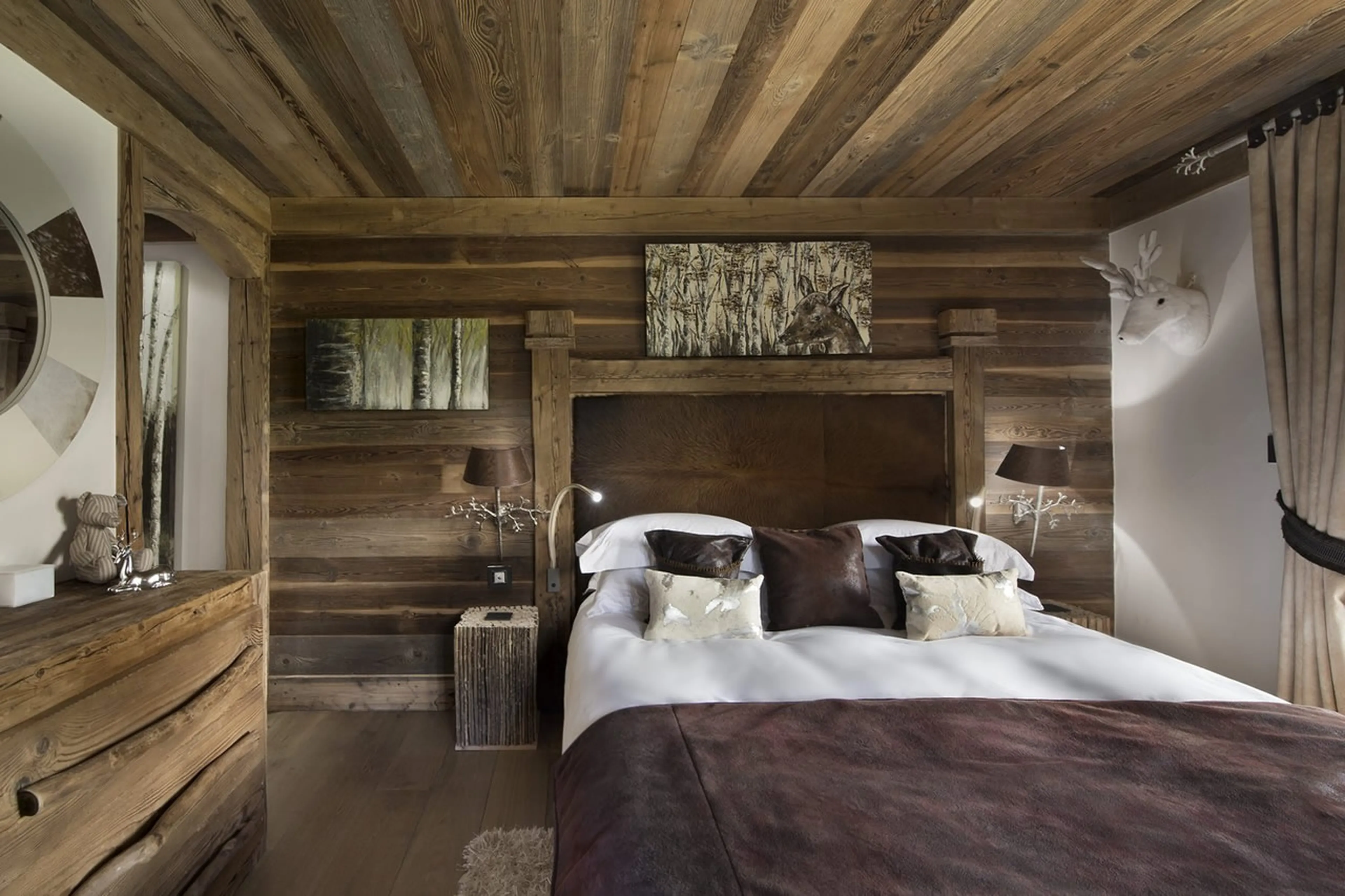 Bedroom with double bed and en-suite shower room in Chalet Makalu in Courchevel 1550