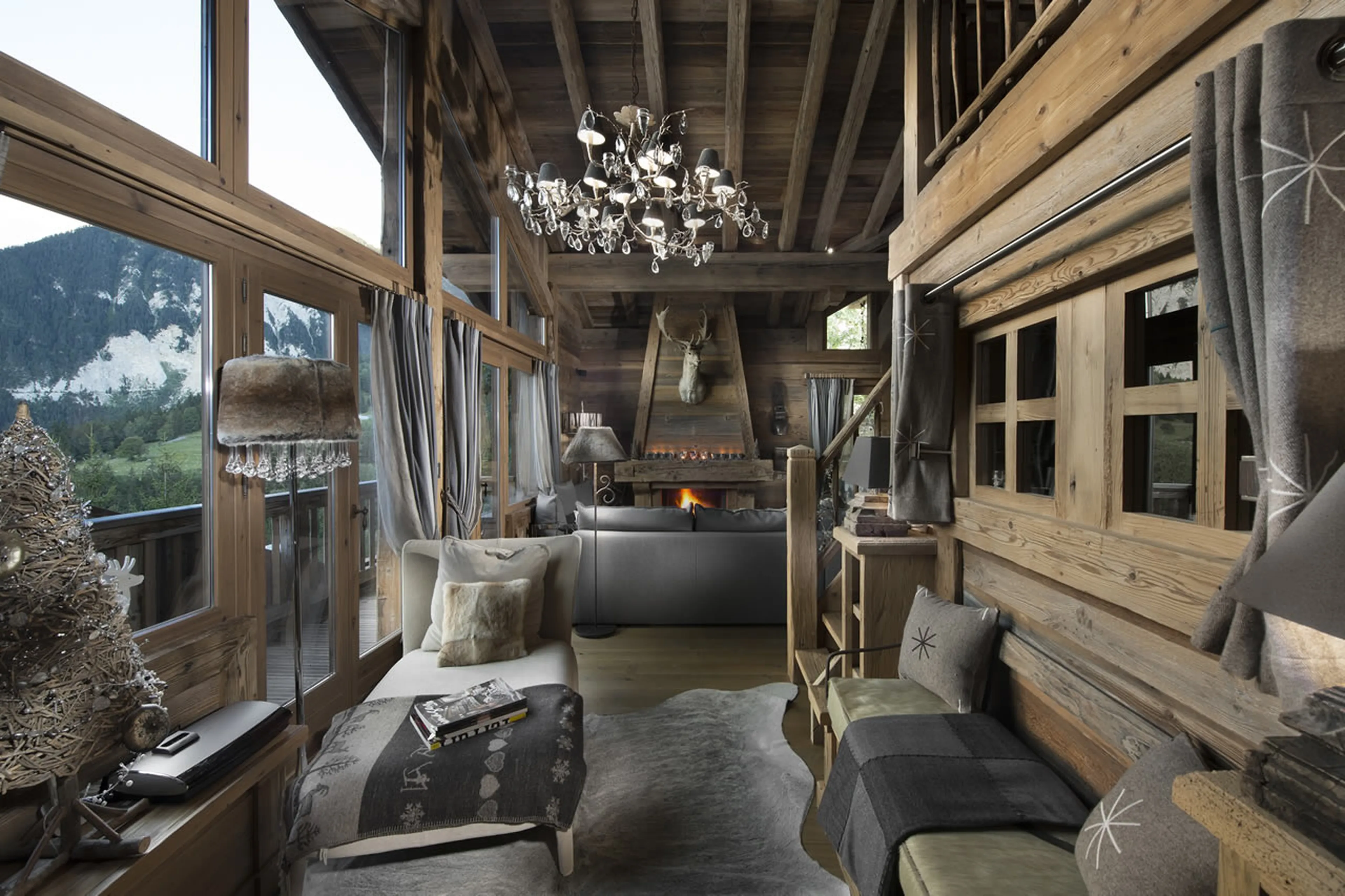 Open-plan living area with fireplace and floor-to-ceiling windows in Chalet Makalu in Courchevel 155