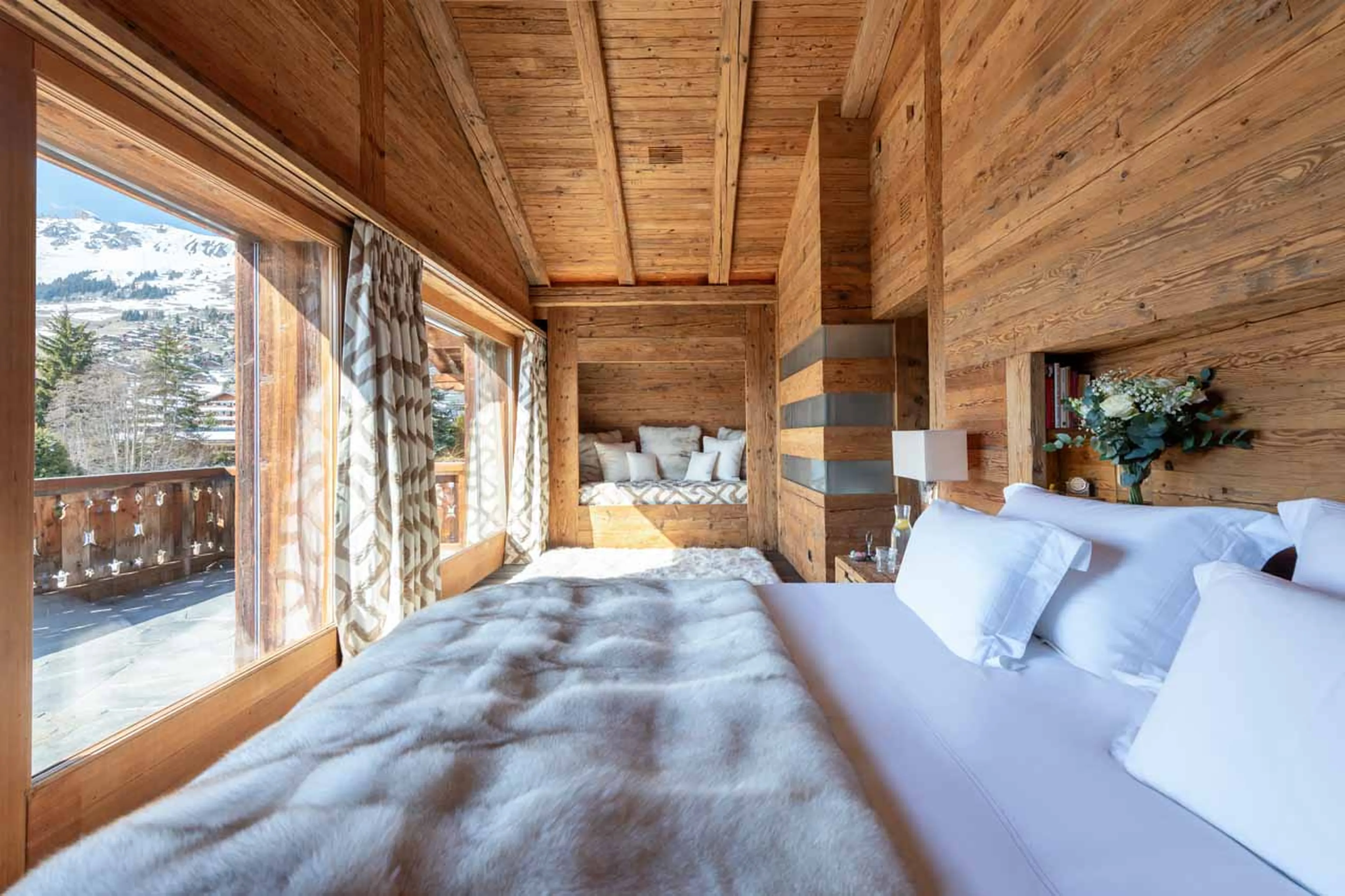 Master bedroom with balcony at Chalet Makini in Verbier
