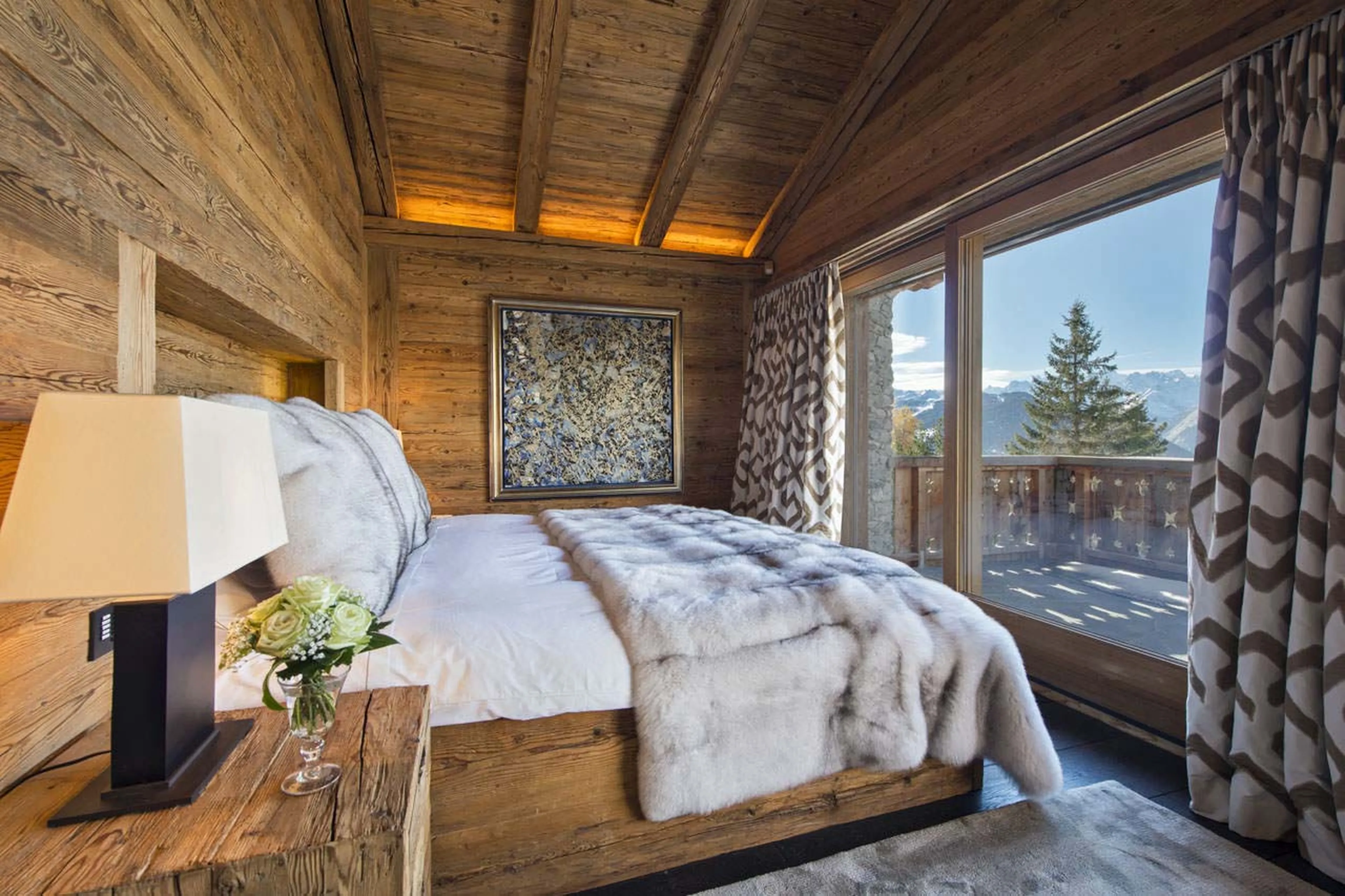 Master bedroom with balcony at Chalet Makini in Verbier
