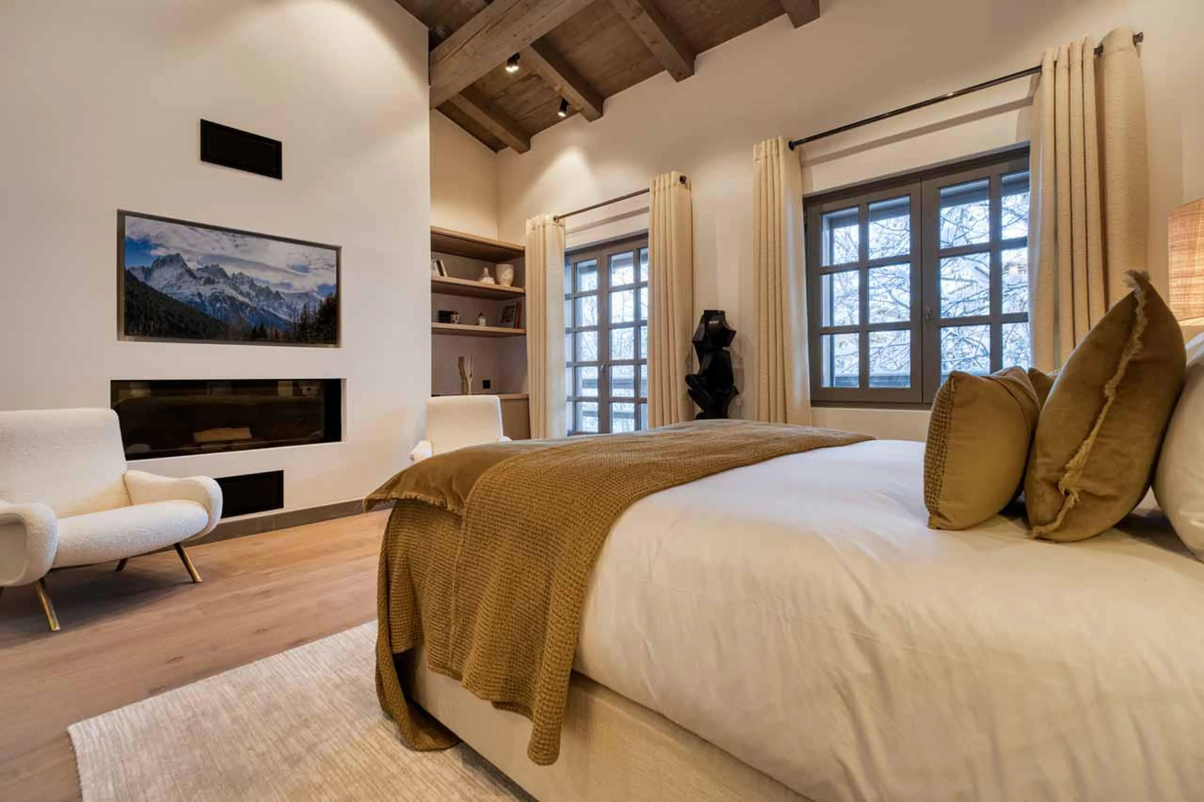 Fireplace in master bedroom at Chalet Mandala in Megeve