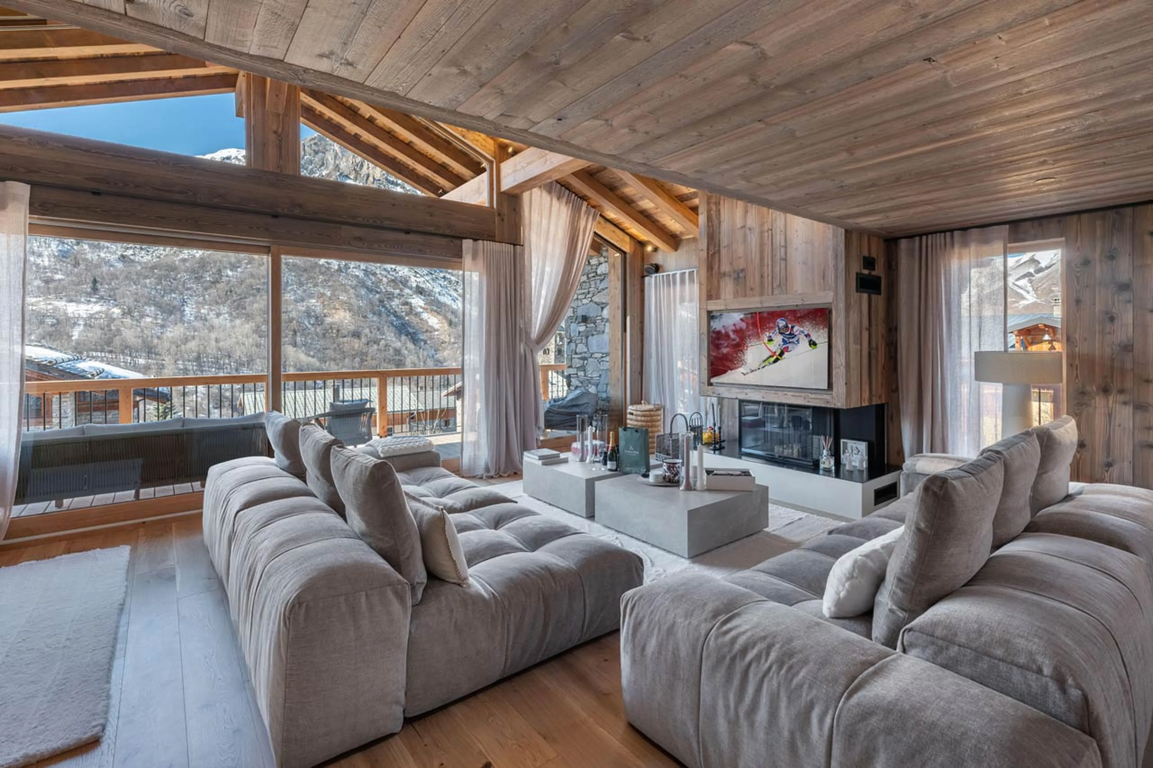 Sofas set around a TV and fireplace in Chalet Marcel, St Martin de Belleville