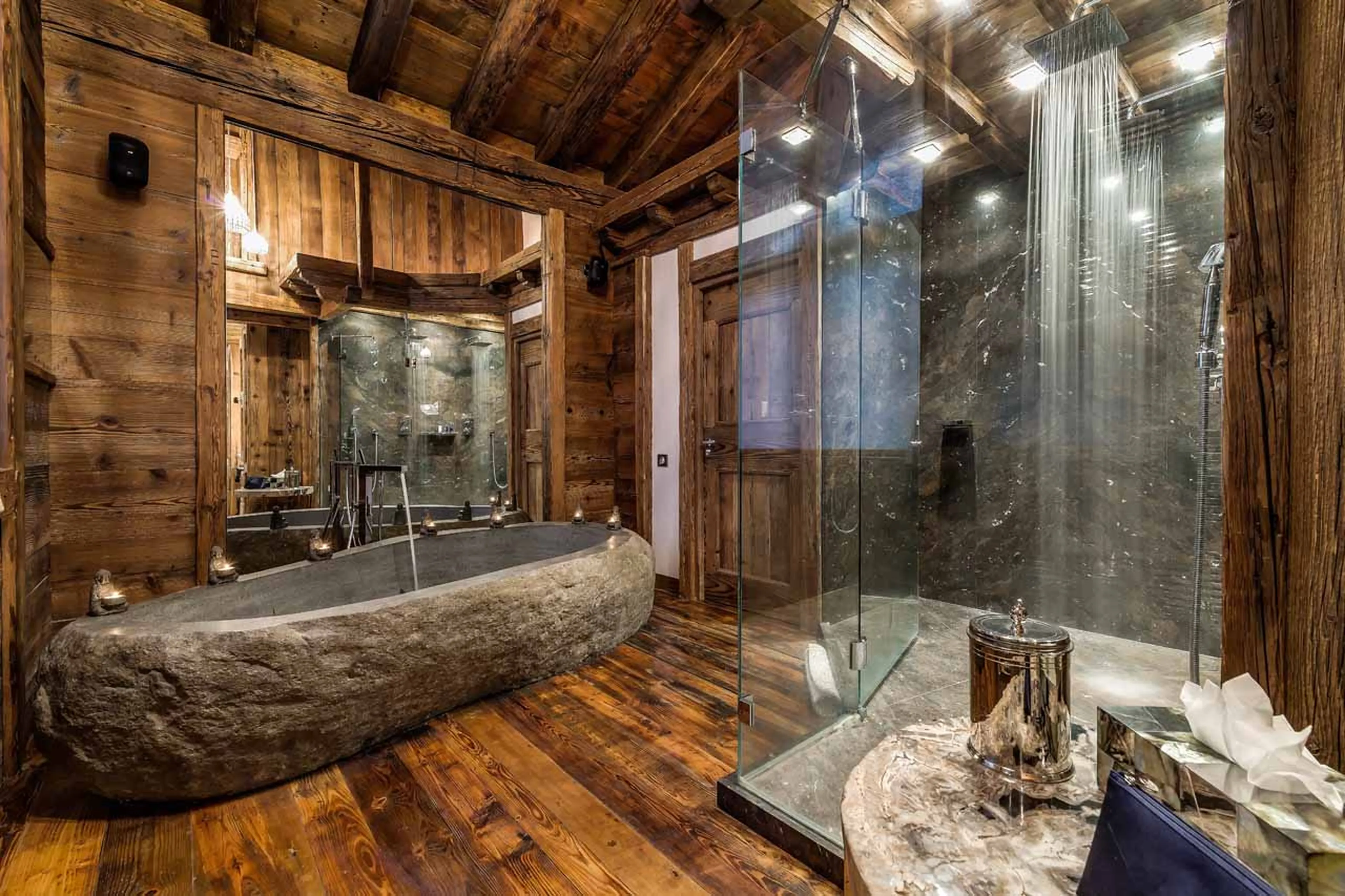 En-suite bathroom with granite bath and shower at Chalet Marco Polo in Val d’ Isere