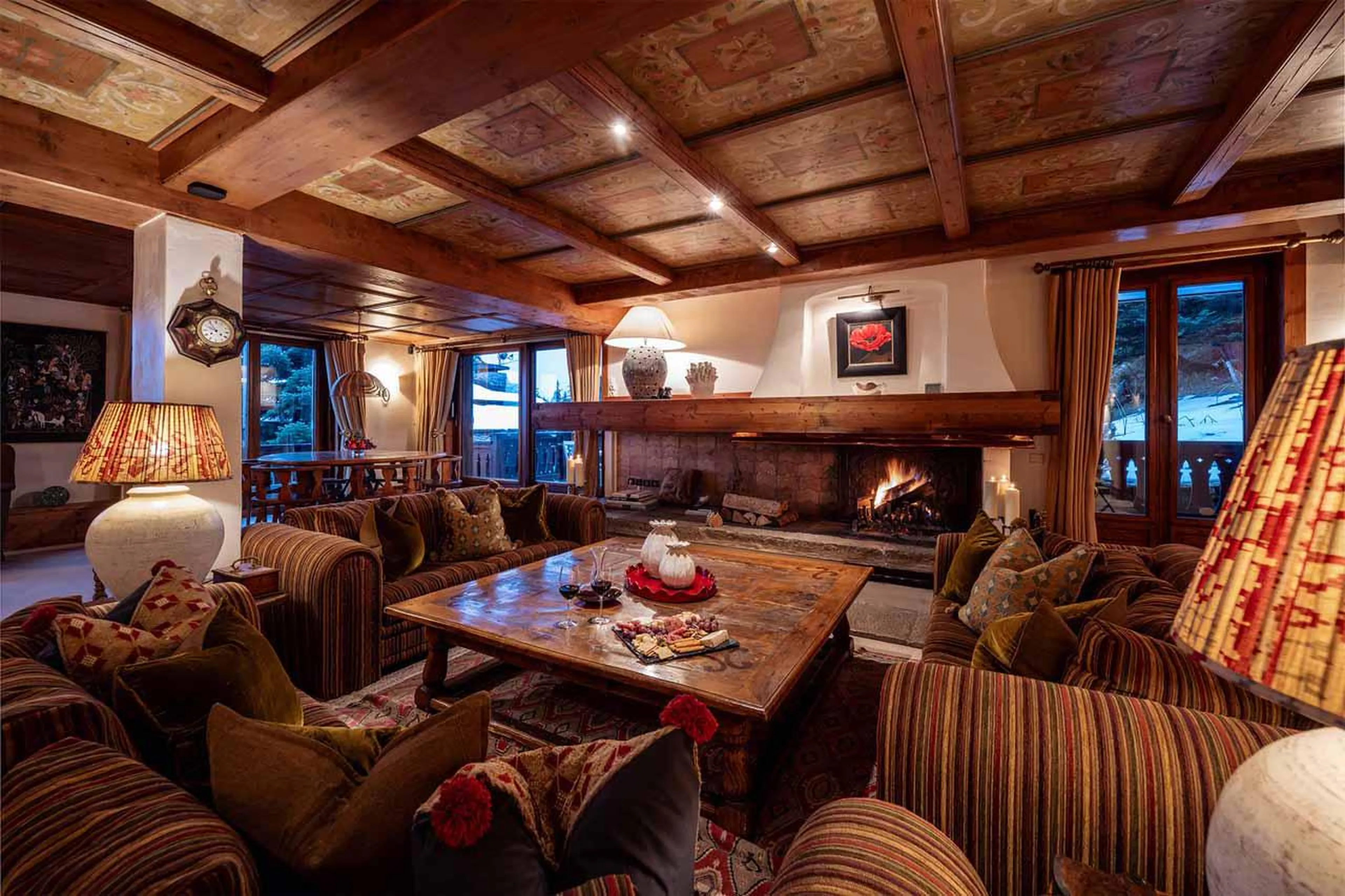 Comfortable seating around wood burning fireplace in Chalet Margaux, Courchevel 1850