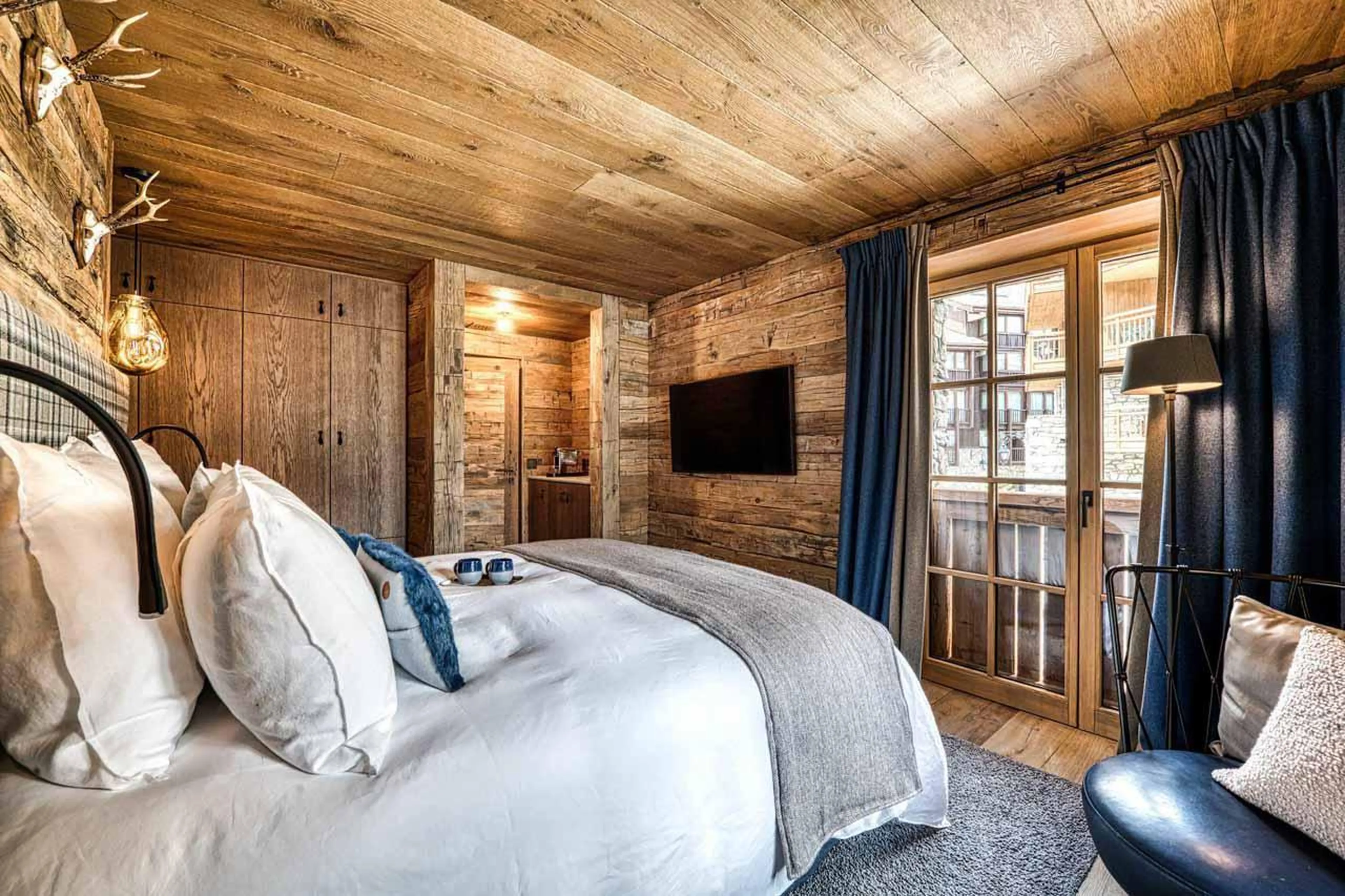 Double bedroom with wall mounted TV in Chalet Markhor, Val d'Isere