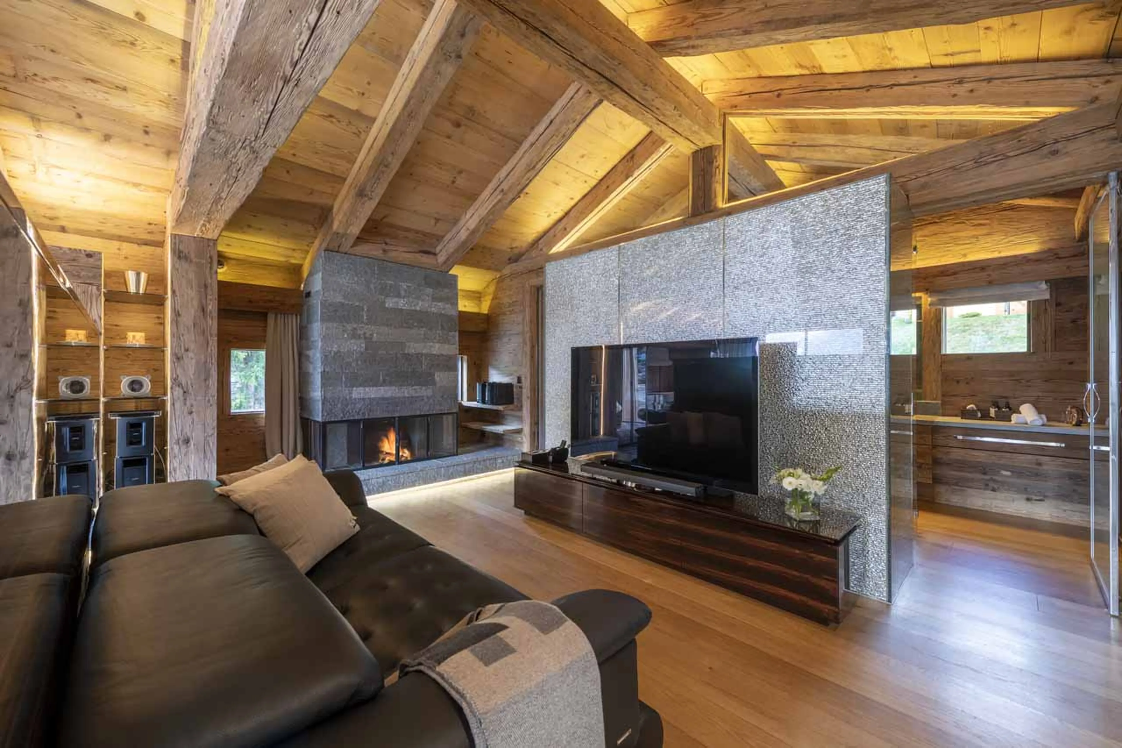 Small living area with TV and fireplace at Chalet Marmottier in Verbier