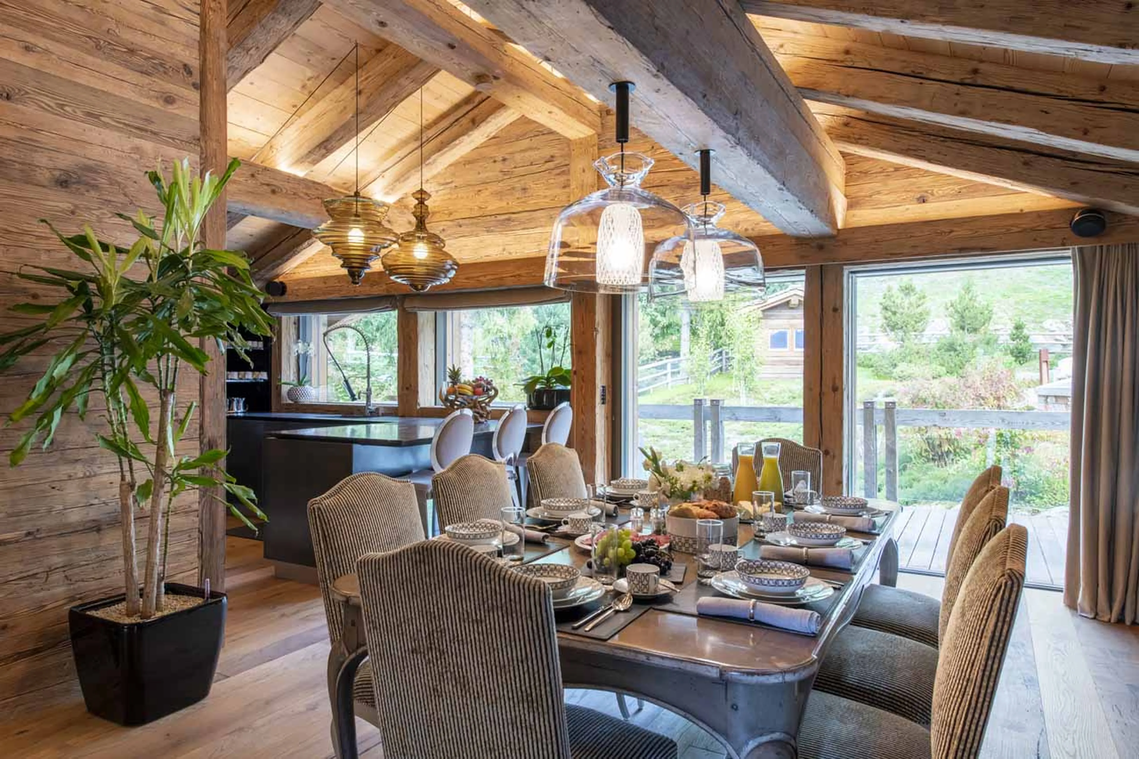 Dining table and kitchen at Chalet Marmottier in Verbier