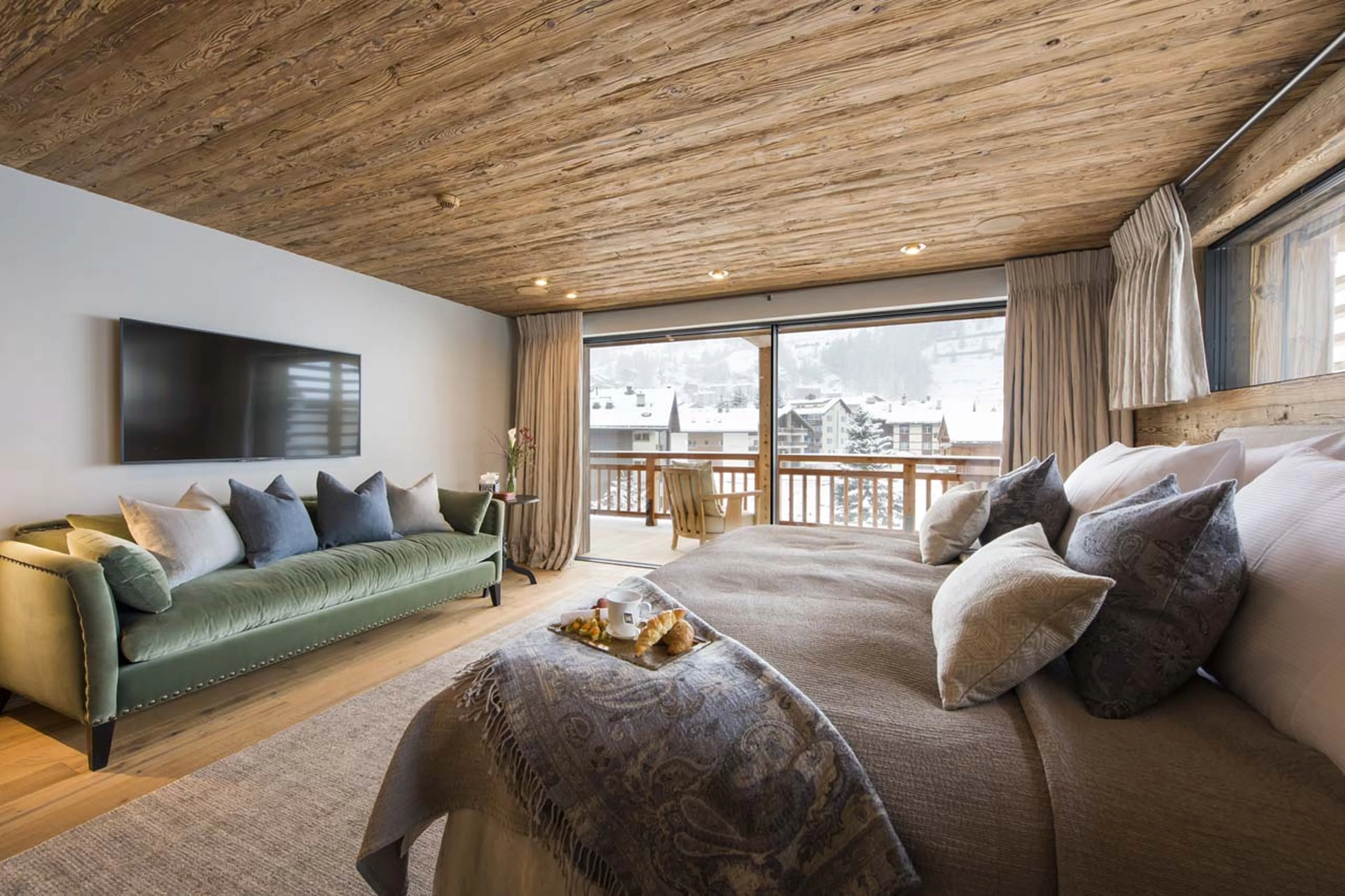 Sofa and TV in master bedroom of Chalet Mckinley in Zermatt