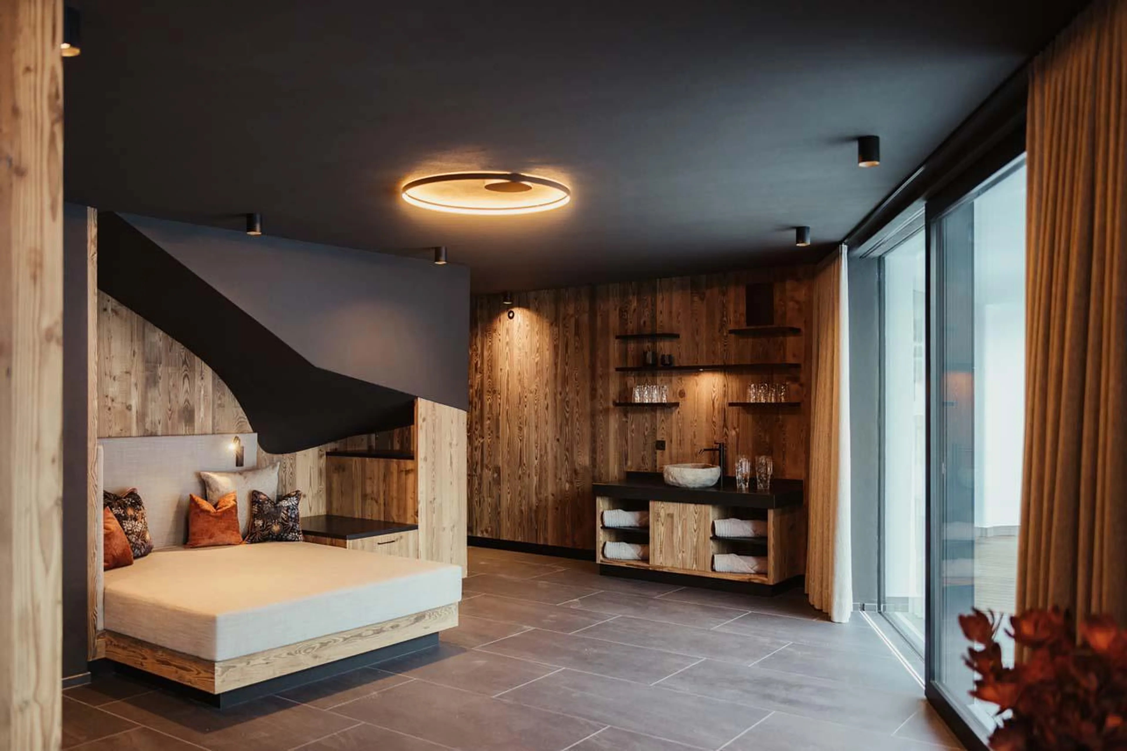 Bright and spacious spa area with floor-to-ceiling windows at Chalet Mile 1 in Val Gardena