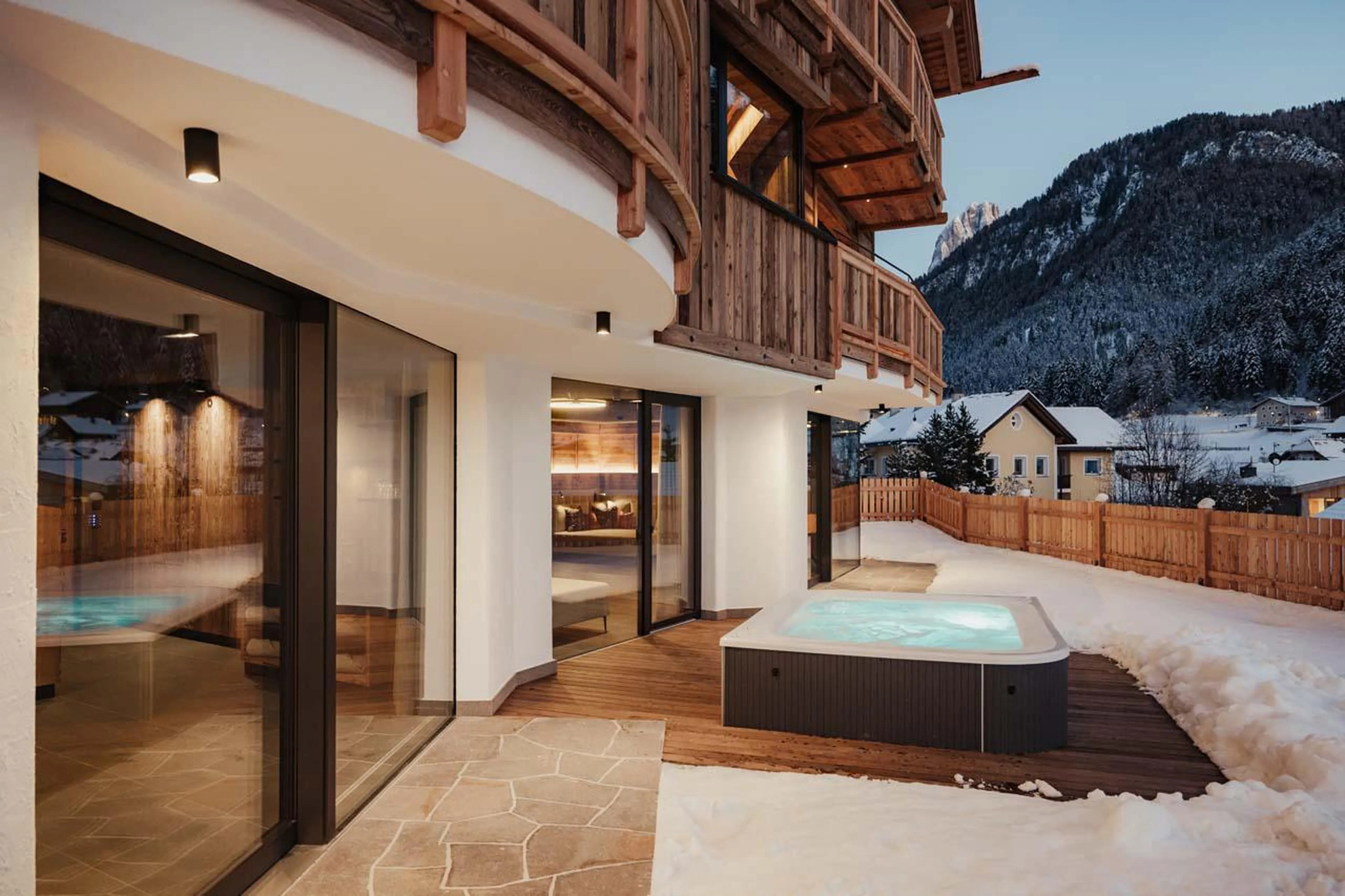 Hot tub on the outdoor terrace offering stunning mountain views at Chalet Mile 2 in Val Gardena