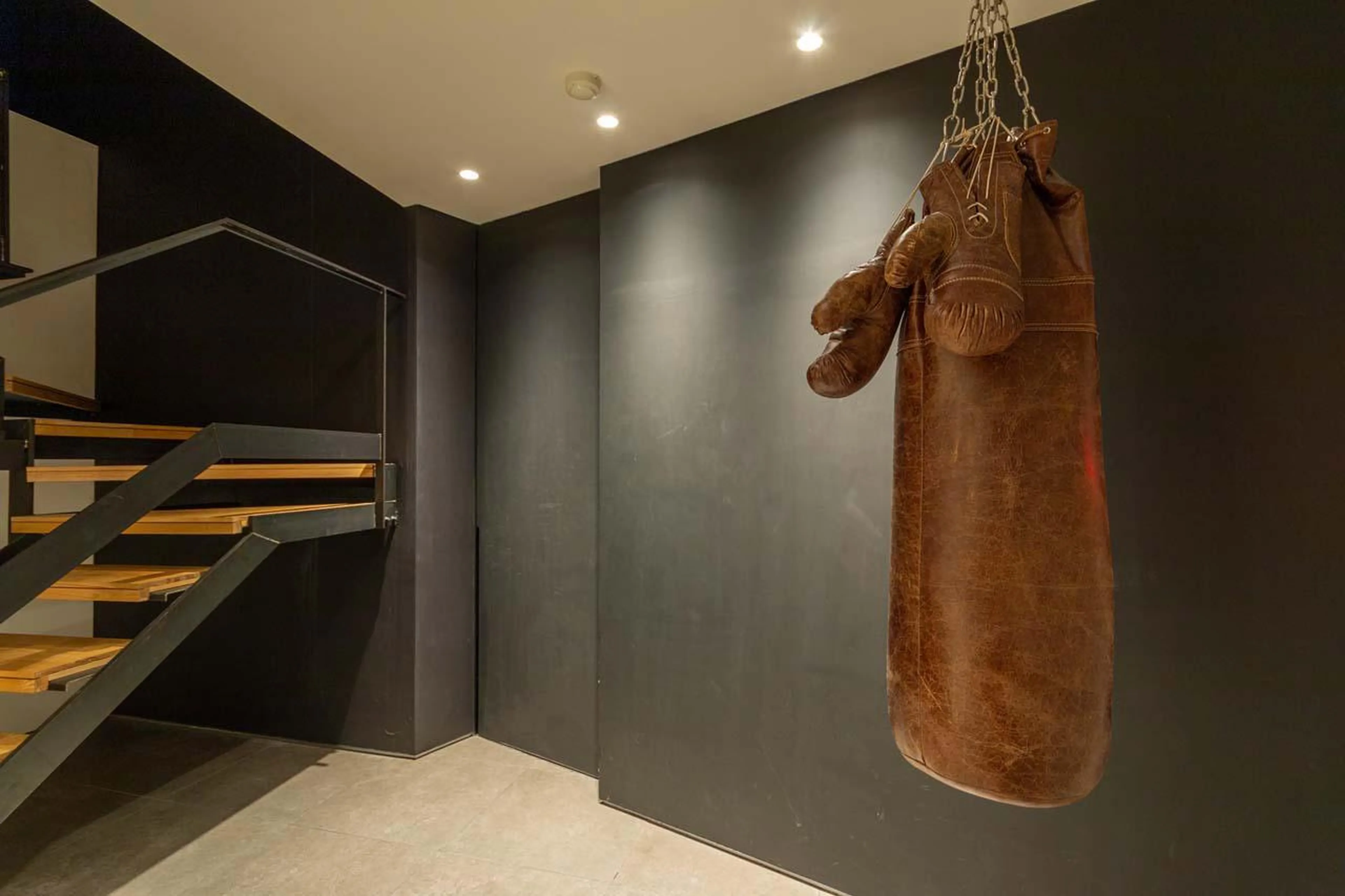 Stairs leading to the first floor living area at Chalet Millesime in Niseko