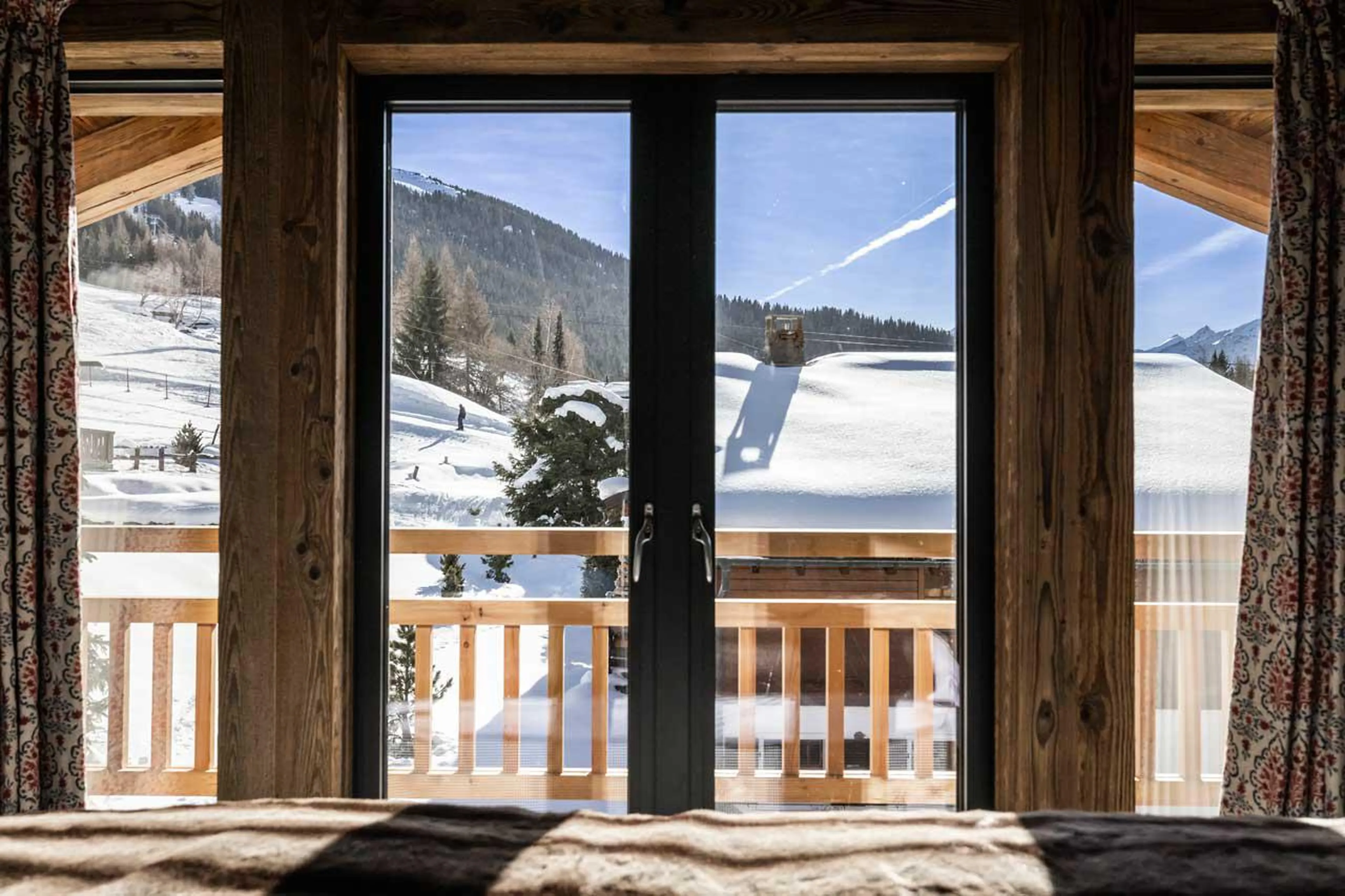 Master bedroom with en-suite bathroom, dressing area, and balcony at Chalet Munro in Verbier