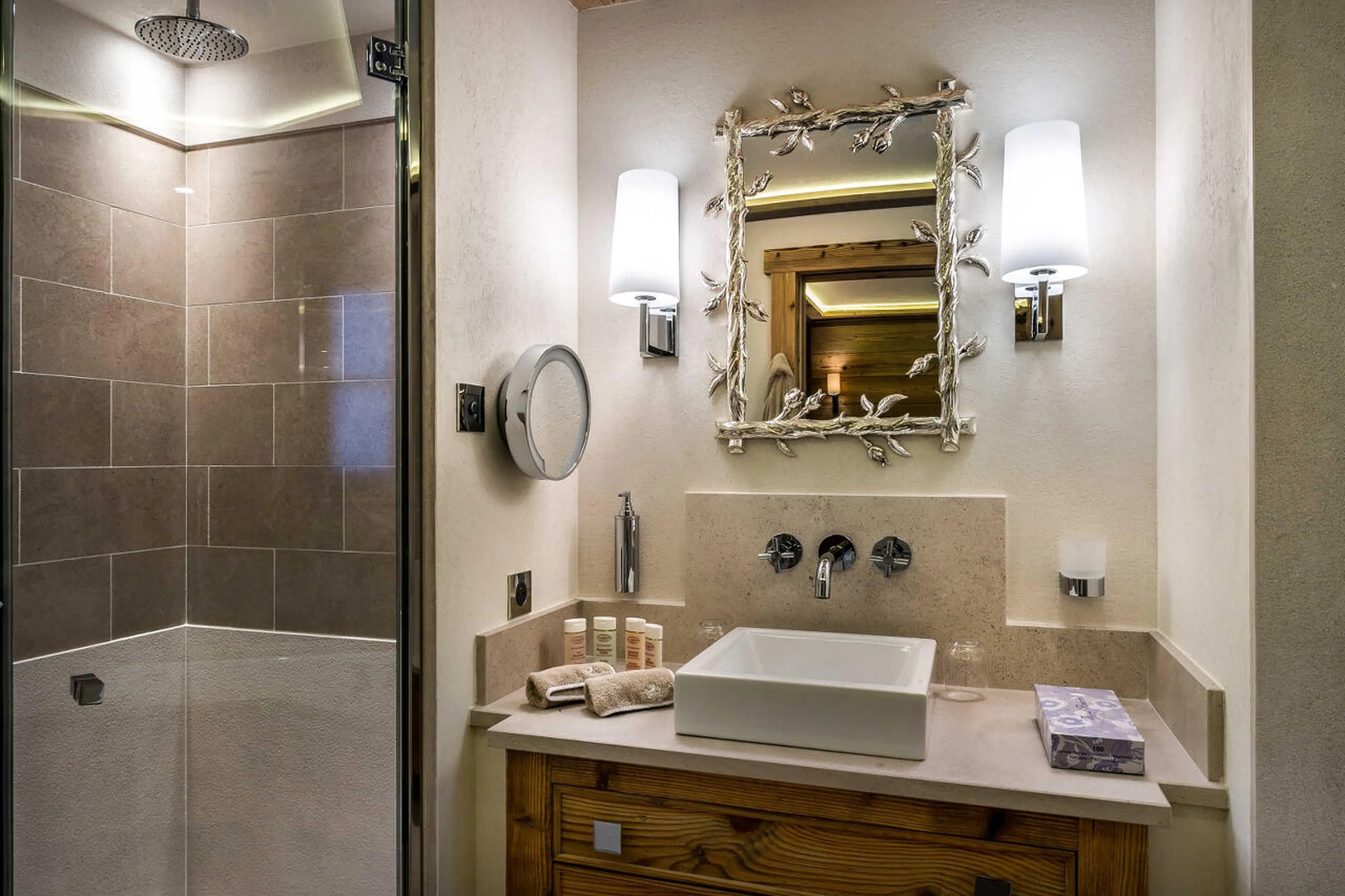 En suite bathroom with bath, shower and single basin in Chalet Nanuq in Courchevel 1850