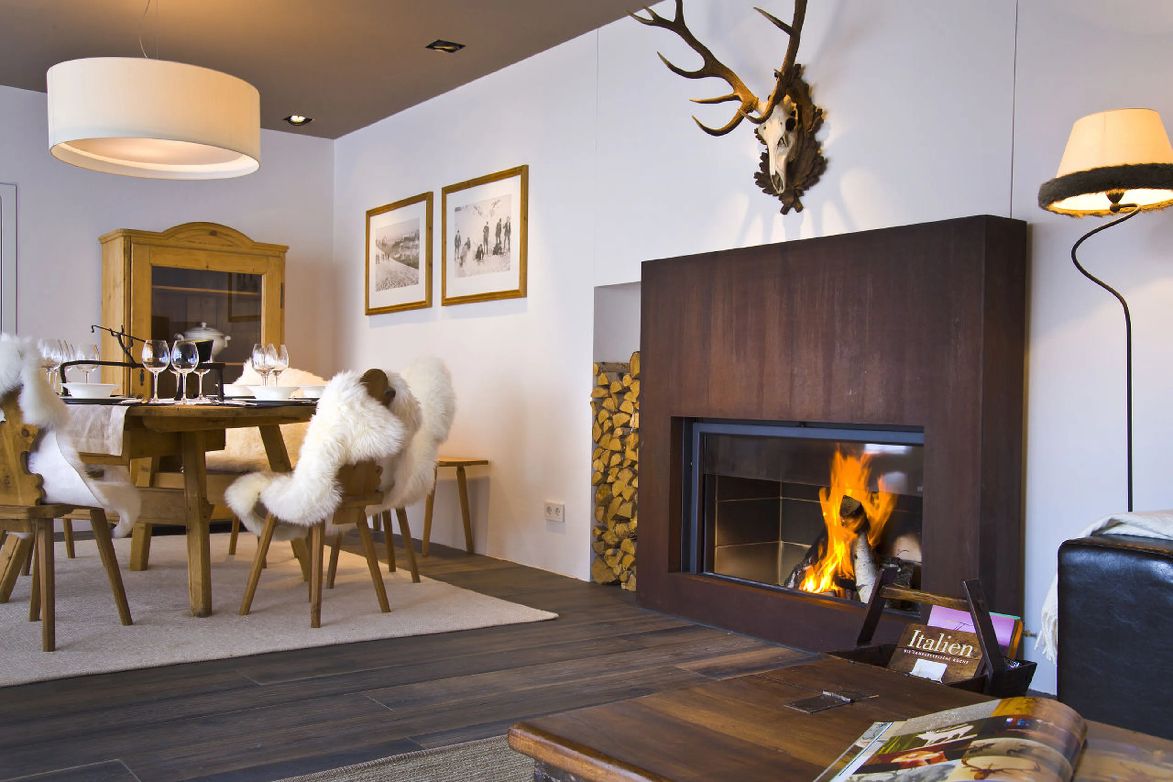 Dining table next to fireplace in Chalet Obertreyen near Kronplatz