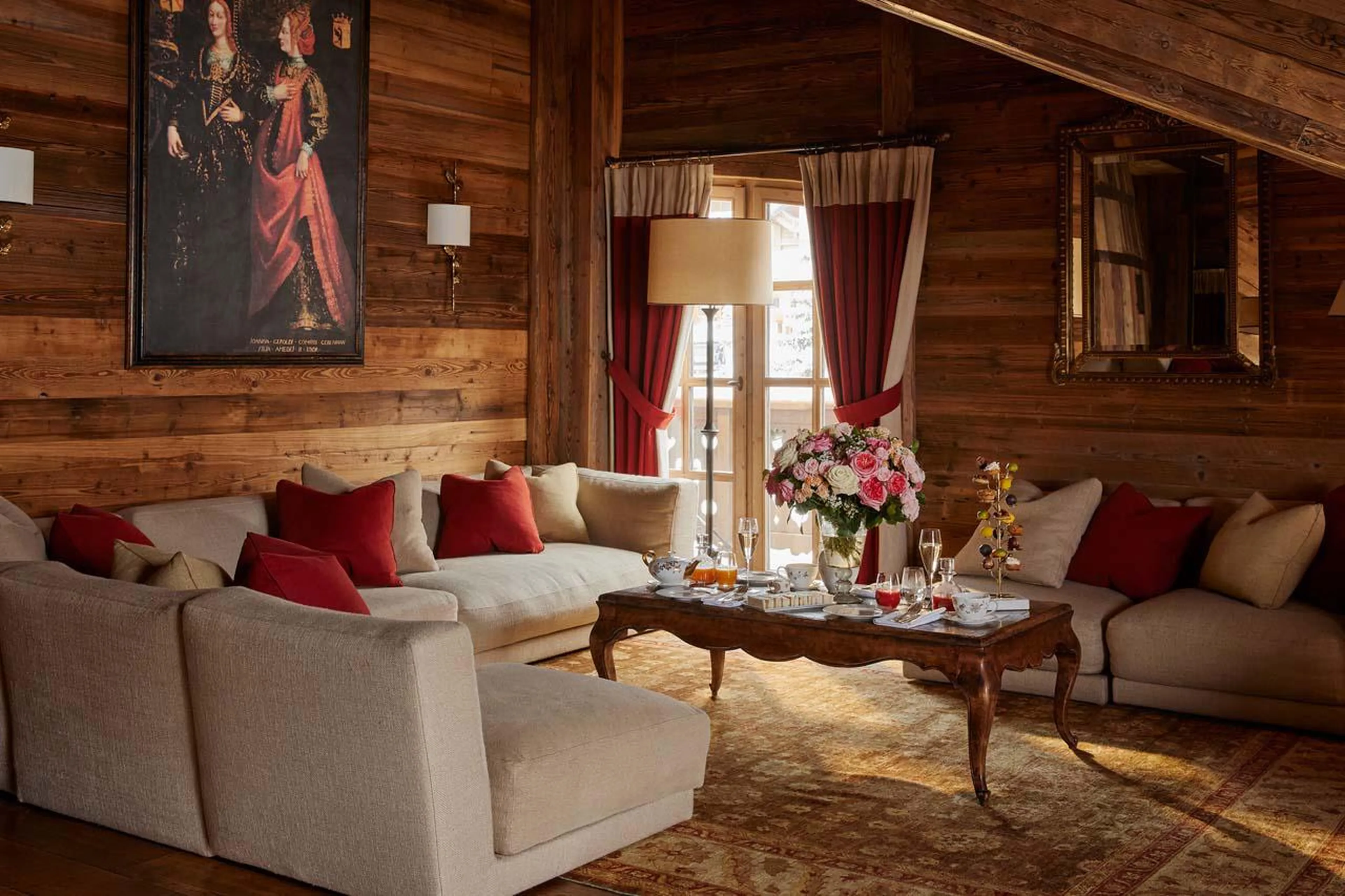 Chalet Ormello in Courchevel 1850 has a large living area with vaulted ceiling and open log fire