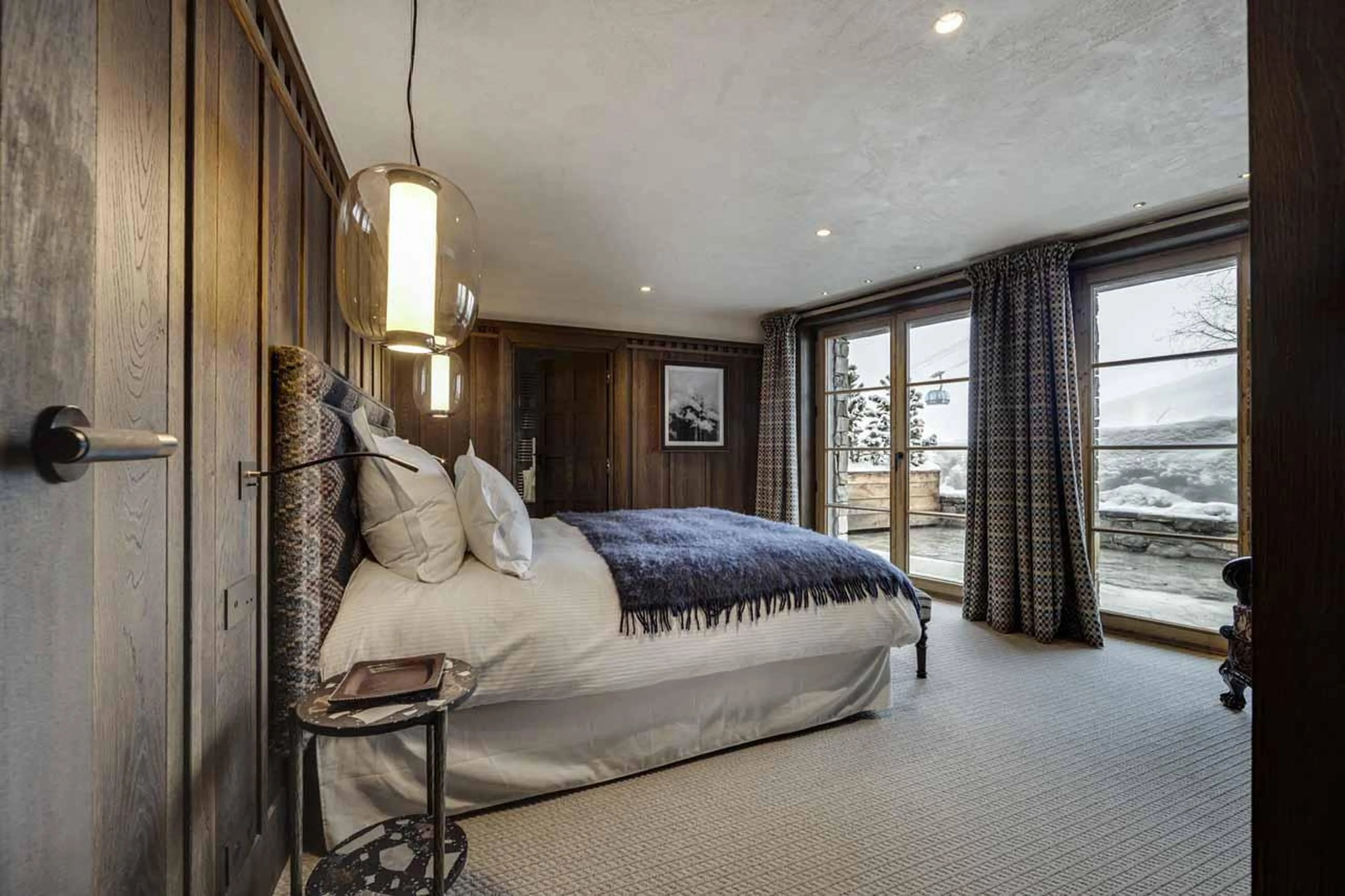 Bedroom one with terrace access at Chalet Ottawa in Val d'Isere