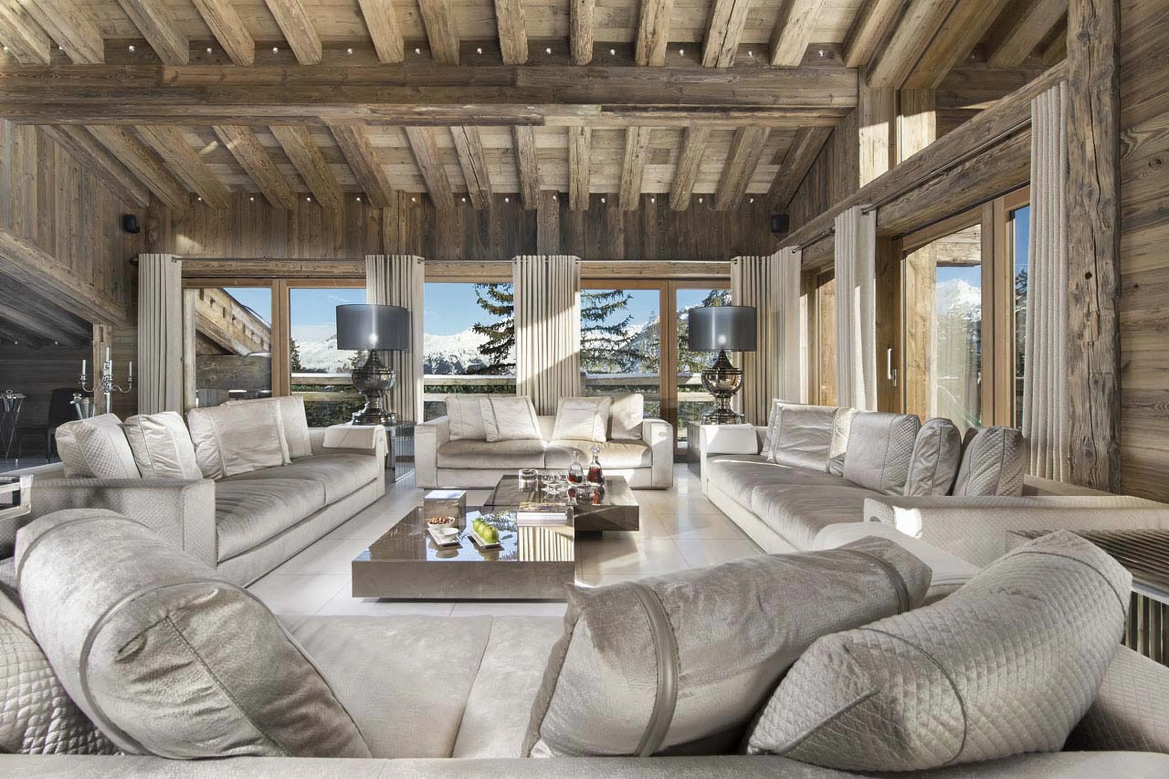 Spacious living area with a view through large windows in Chalet Owens in Courchevel 1850