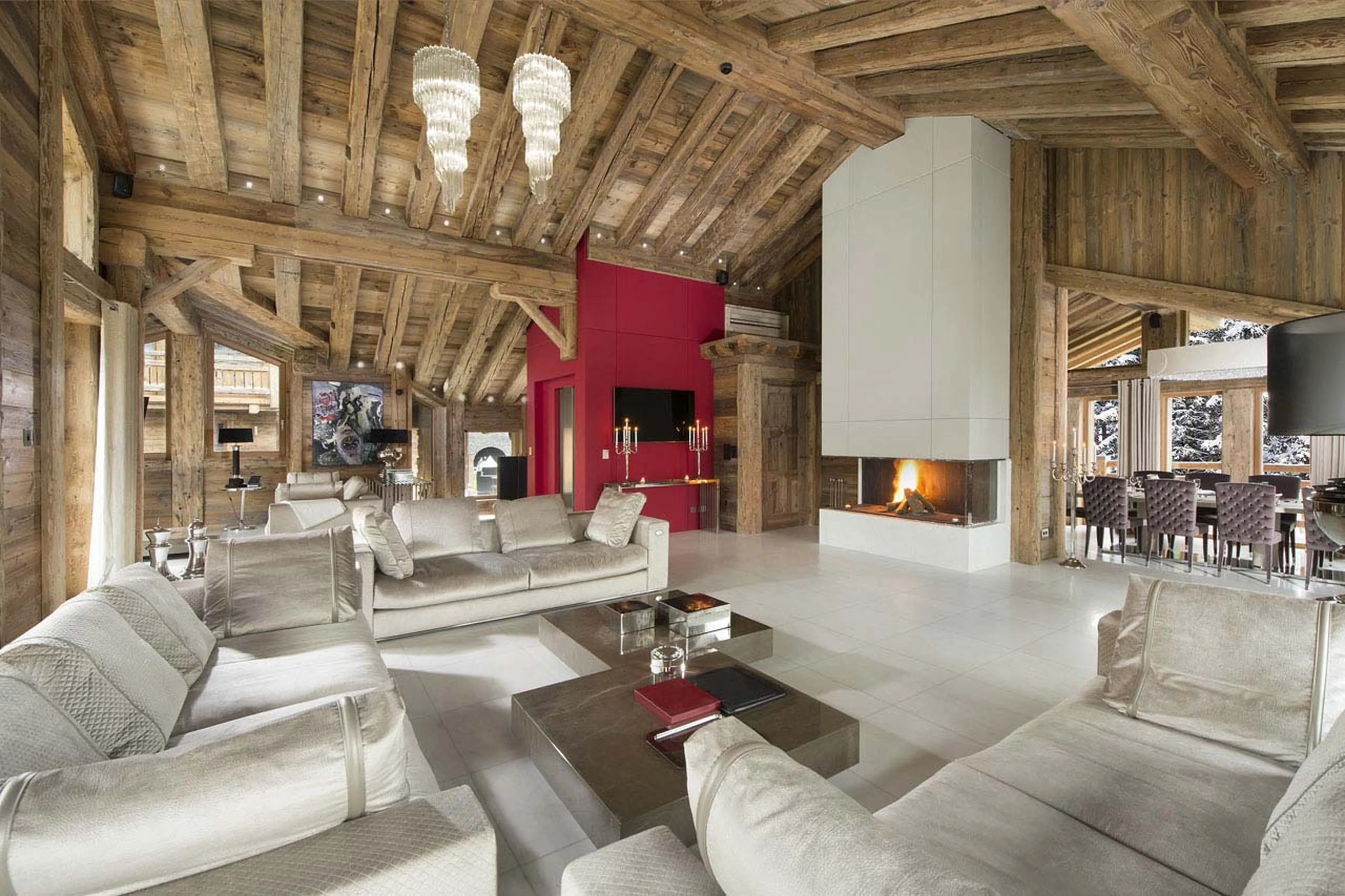 Open plan living area with its fireplace in Chalet Owens in Courchevel 1850