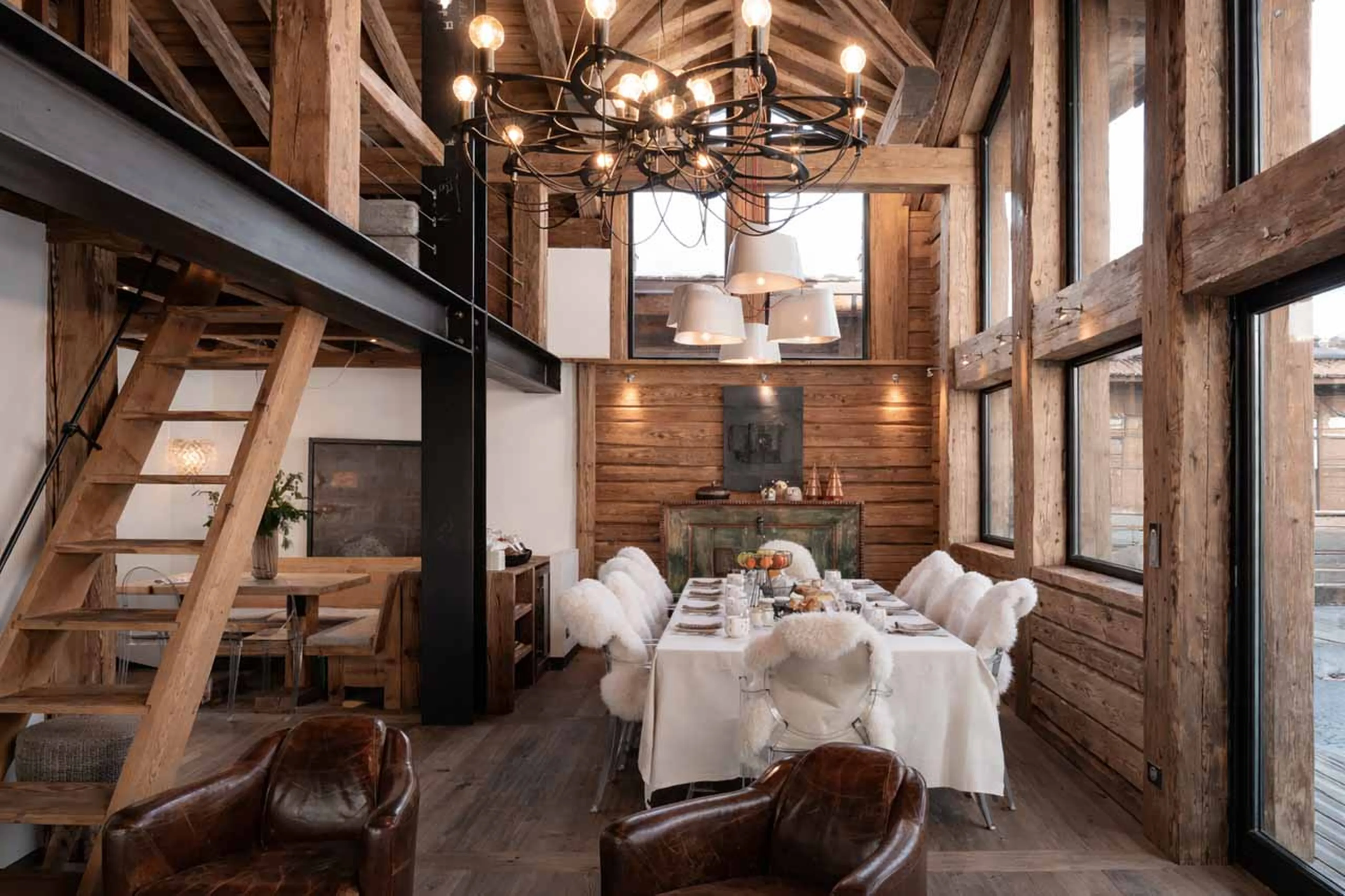 Living area with access to terrace and stairs to mezzanine at Chalet Le Papillon in Val d'Isere