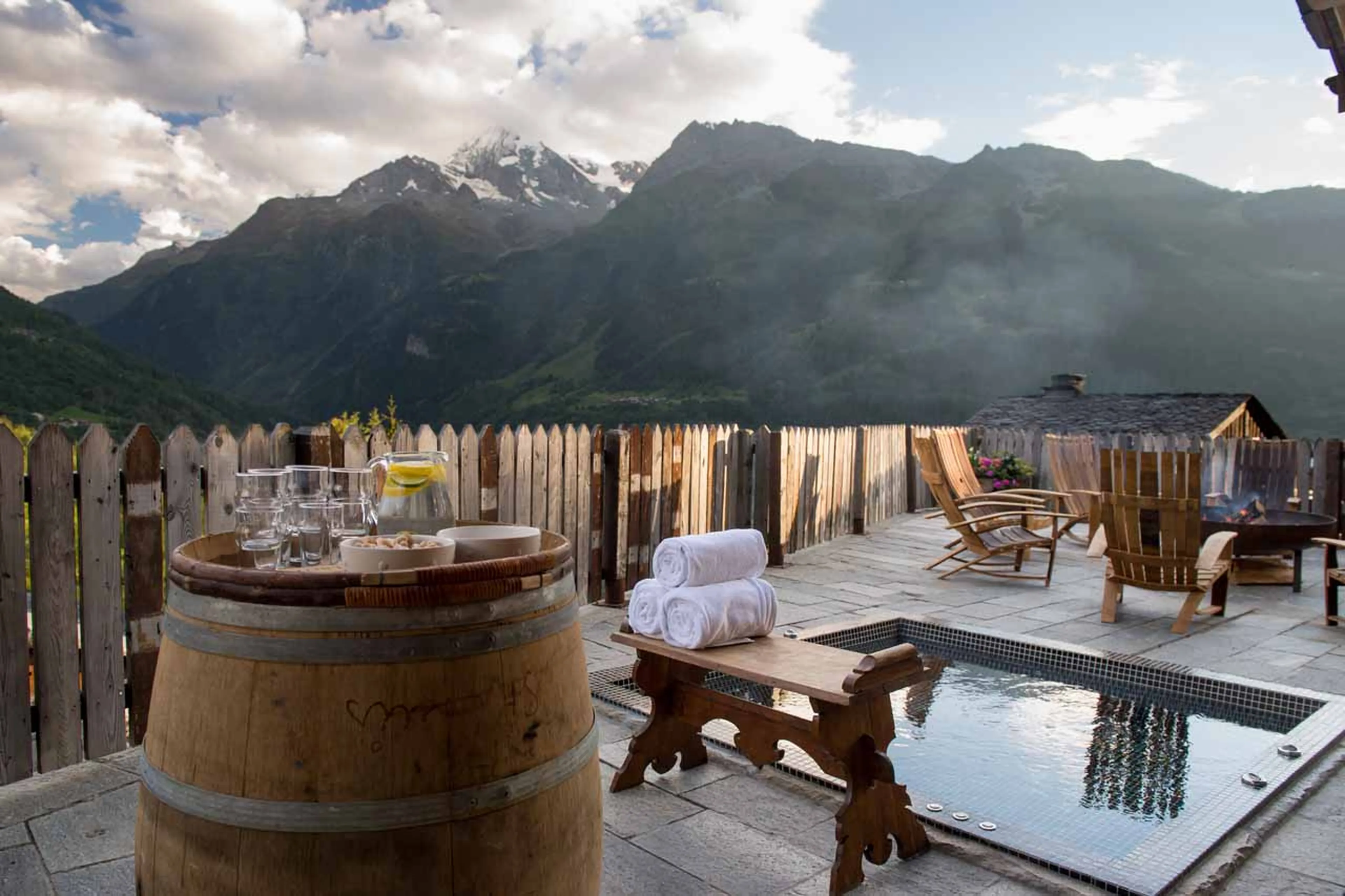 Hot tub on terrace in summer at Chalet Pelerin in Le Miroir