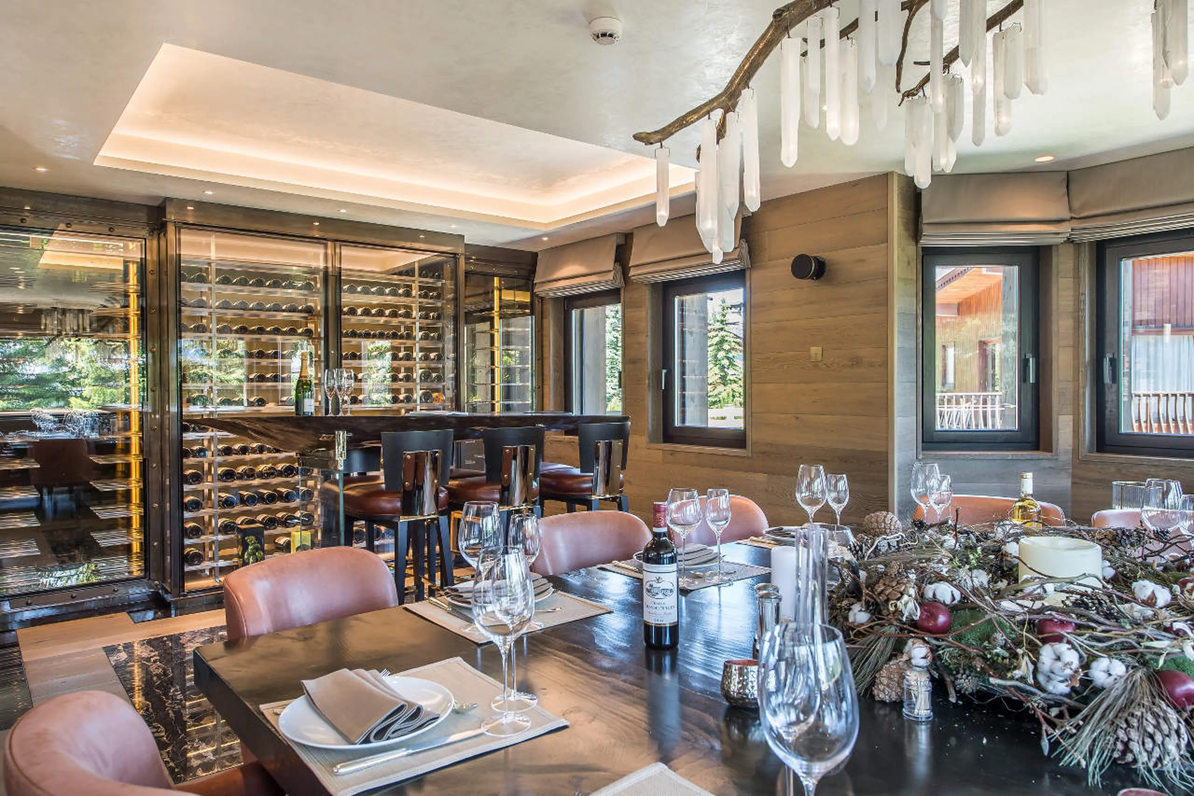 Wine cellar next to dining table in Chalet Perce Neige, Courchevel 1850