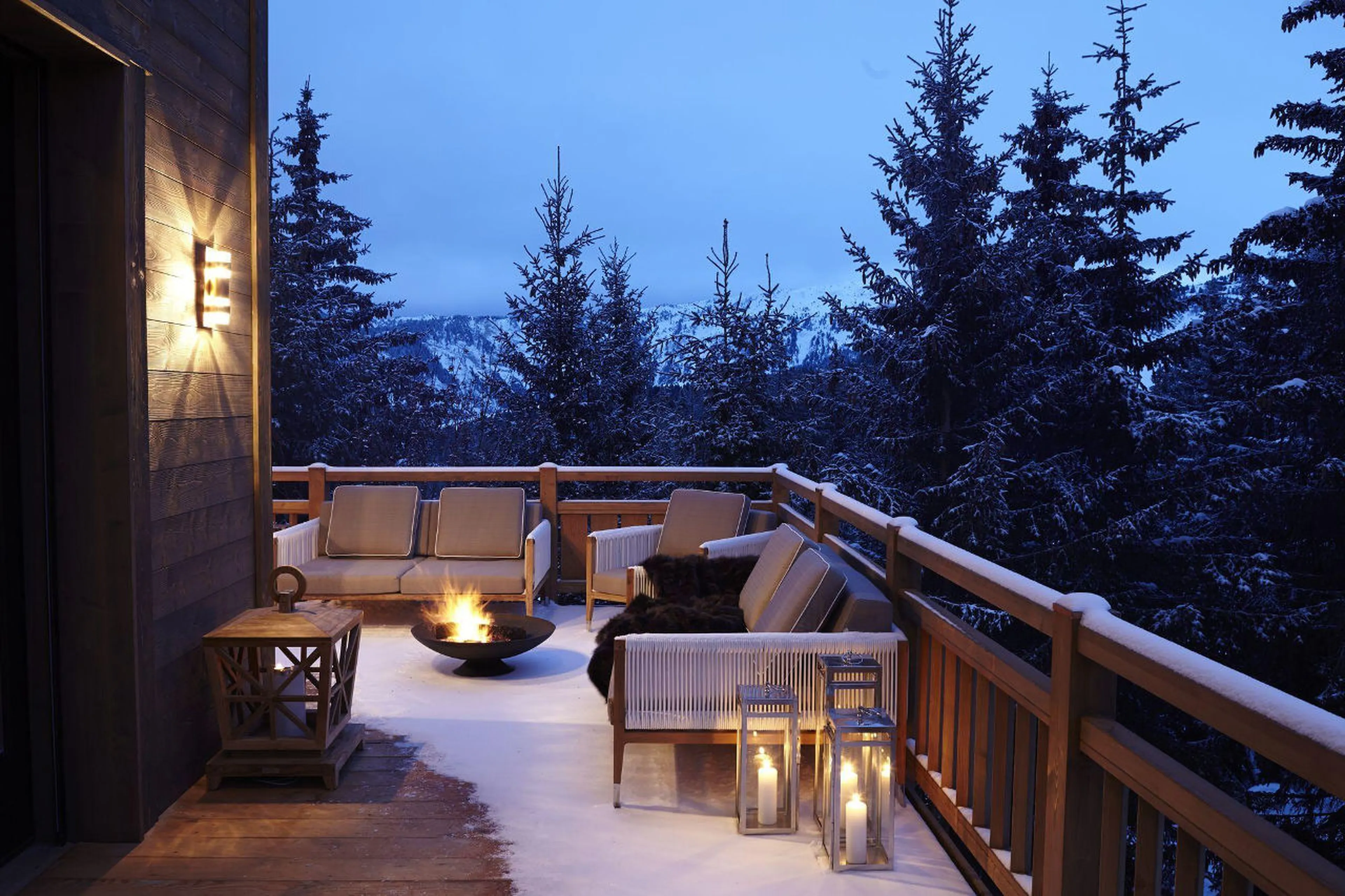 Outdoor dining around a fire pit on a balcony of Chalet Perce Neige in Courchevel 1850