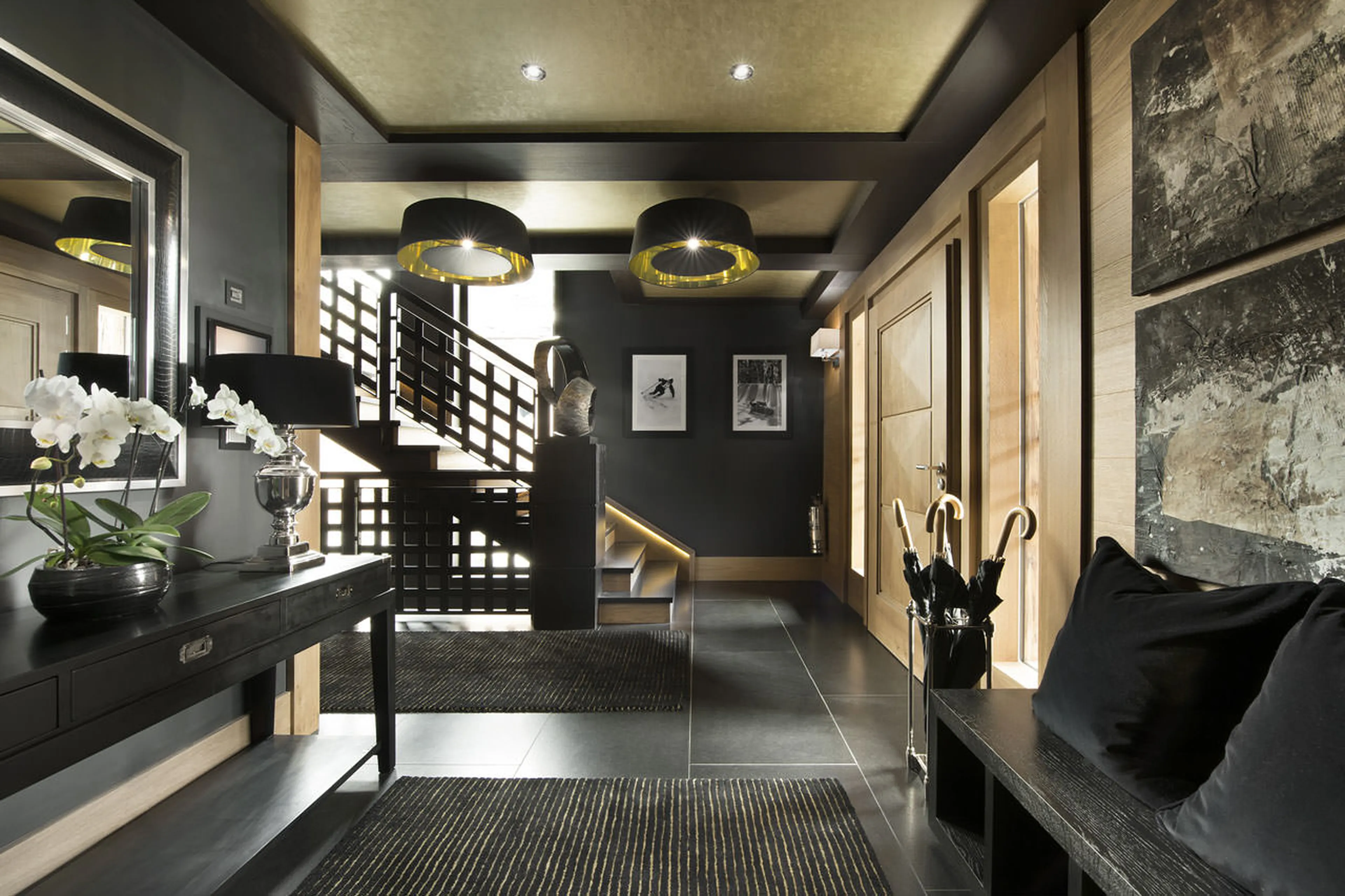 Entrance hall with bold staircase in chalet Le Petit Palais in Courchevel 1850