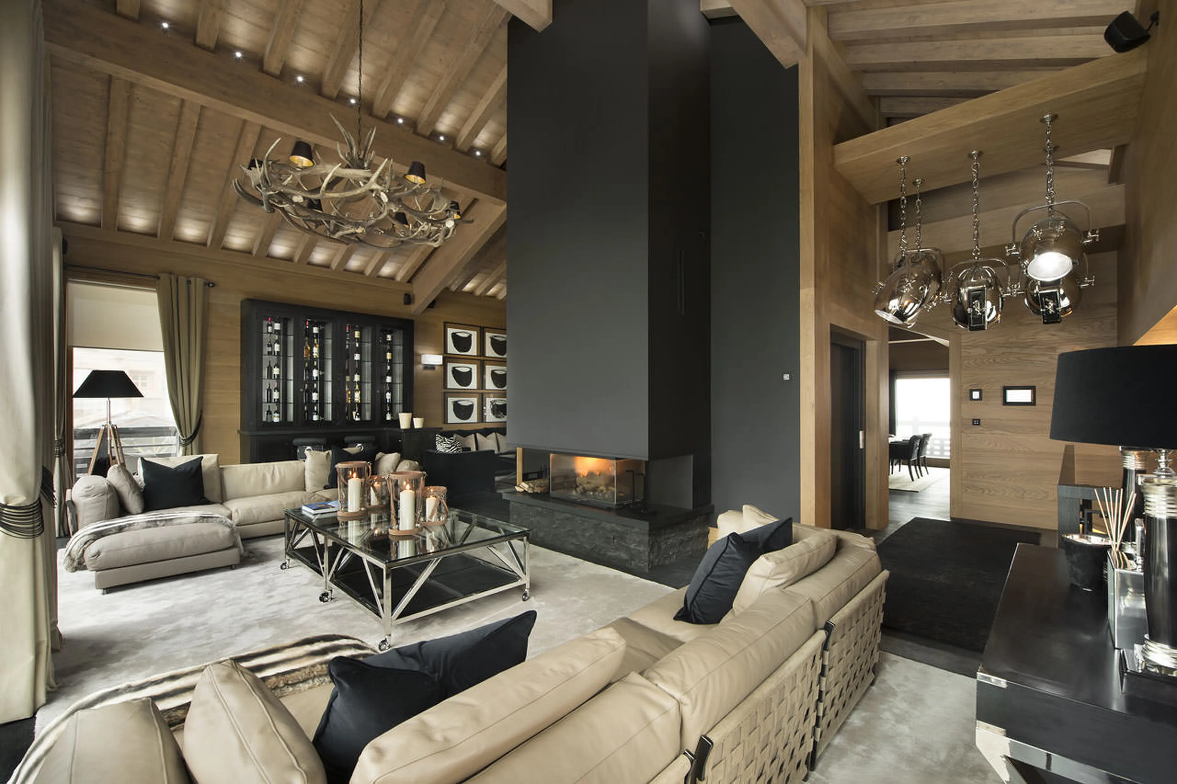 Living room arranged around the fireplace in chalet Le Petit Palais in Courchevel 1850