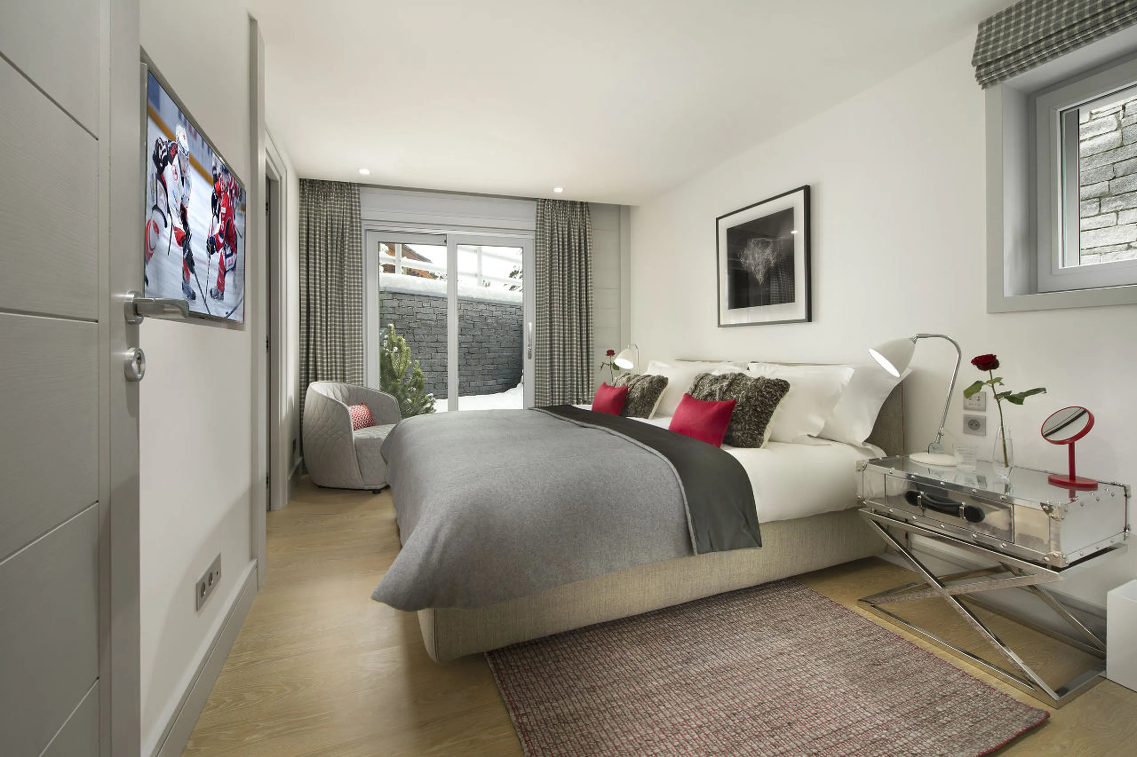 Bedroom with double bed and en-suite shower room in Chalet Pow Pow inCourchevel 1850