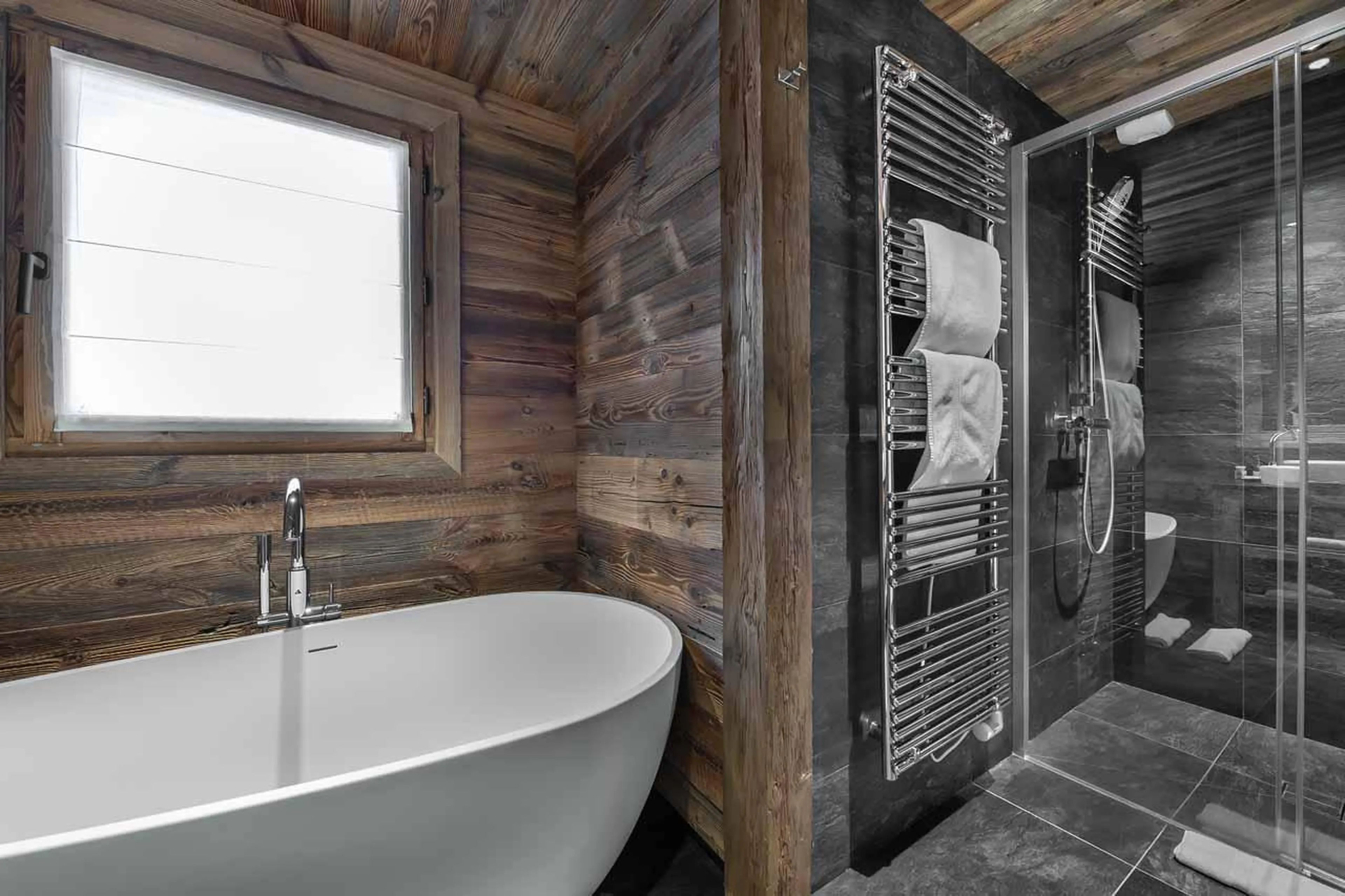 Shower and bathtub at  Chalet Pure Black Crystal in St Martin de Belleville