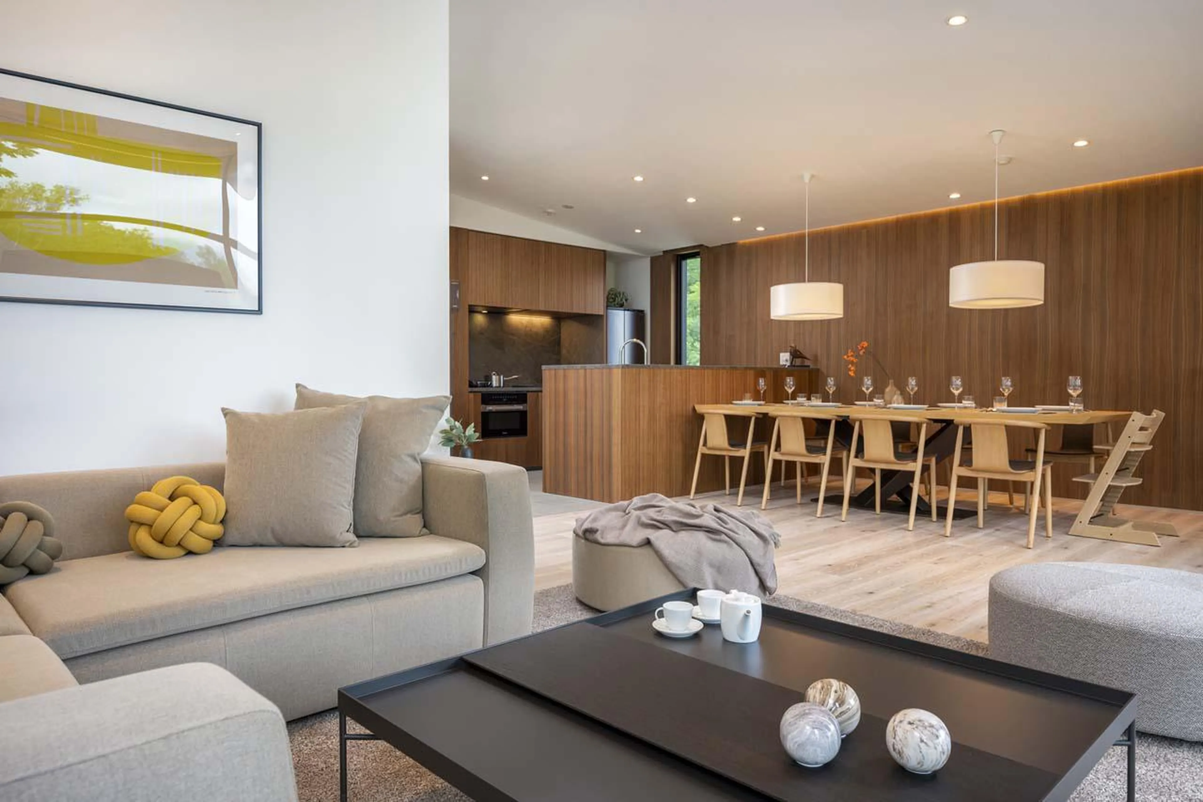 Living area with sofa space, dining table and kitchen at Chalet Ryoun in Niseko