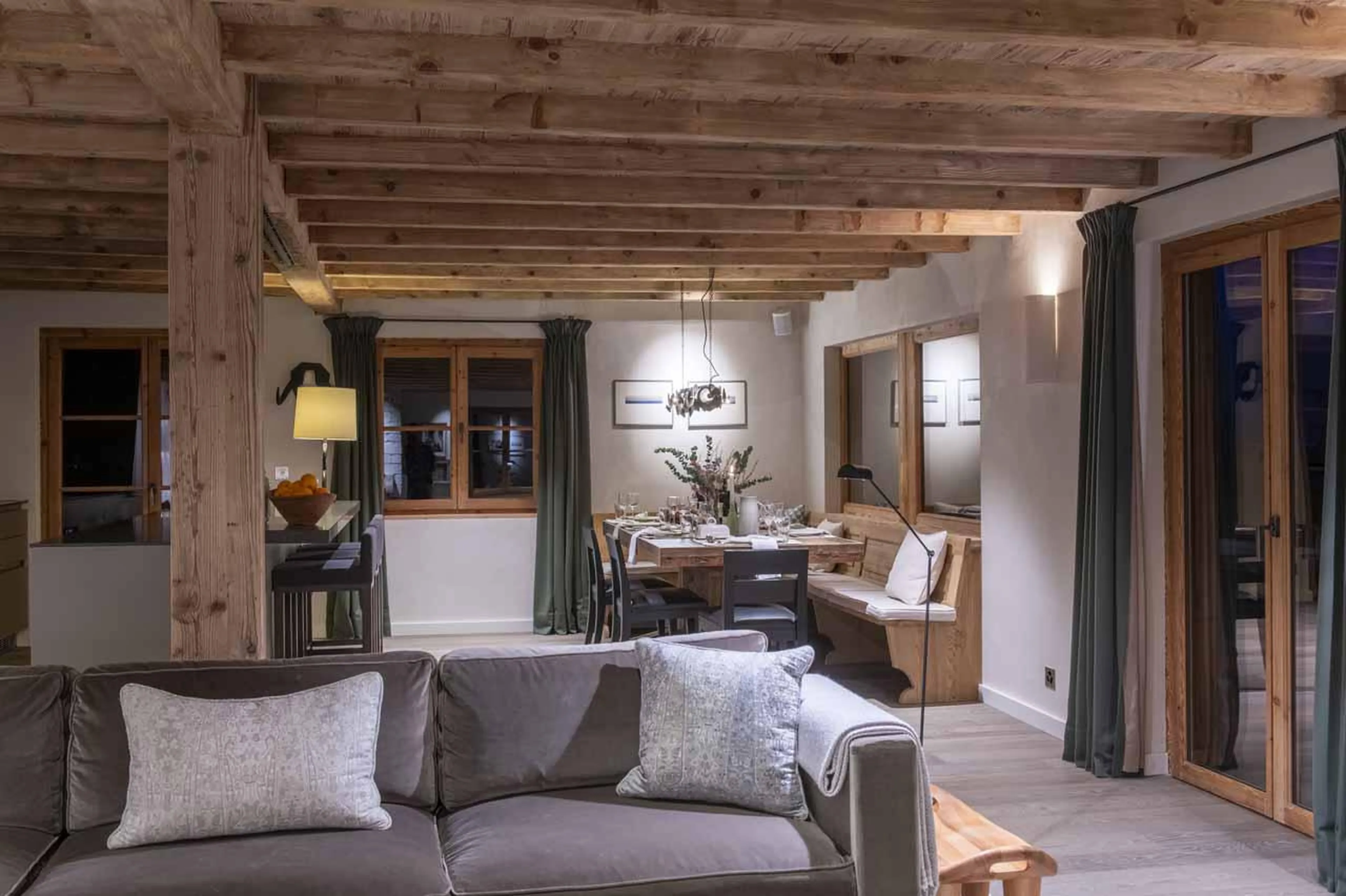 View of dining area and kitchen island from living area at Chalet Scandinavia, Verbier, Switzerland