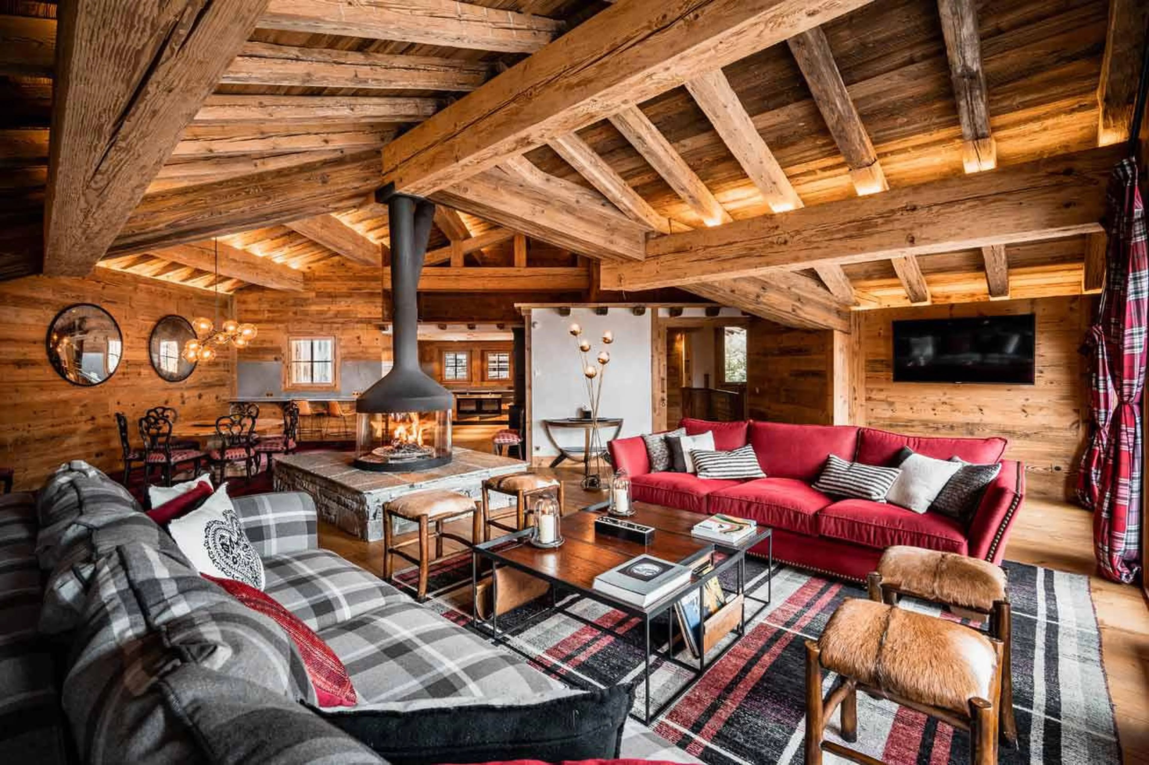 Central fireplace in lounge area of living space of Chalet Sequoia in Val d’ Isere