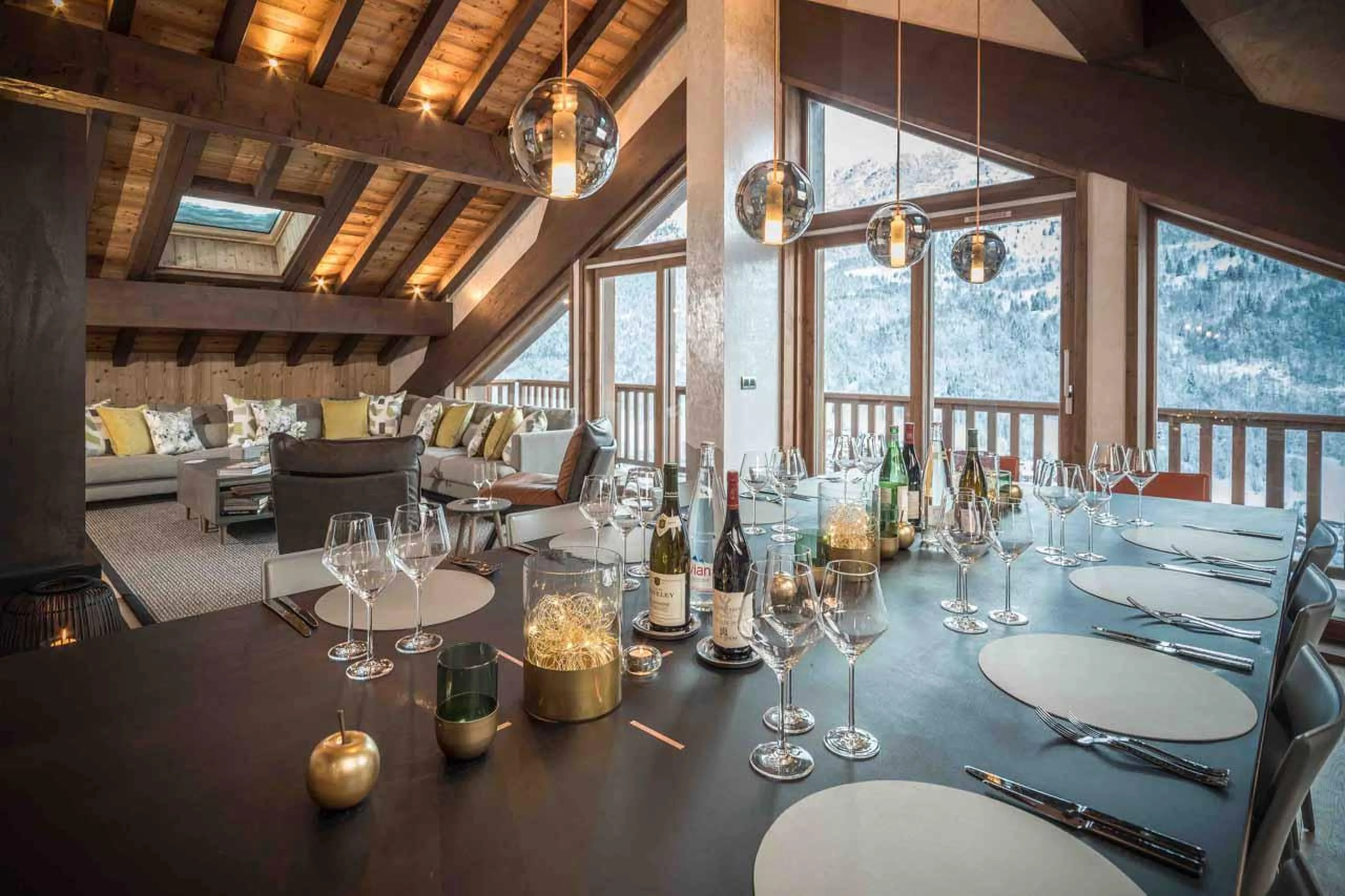 Dining table and vaulted windows and glass doors in Chalet Serendipity, Meribel