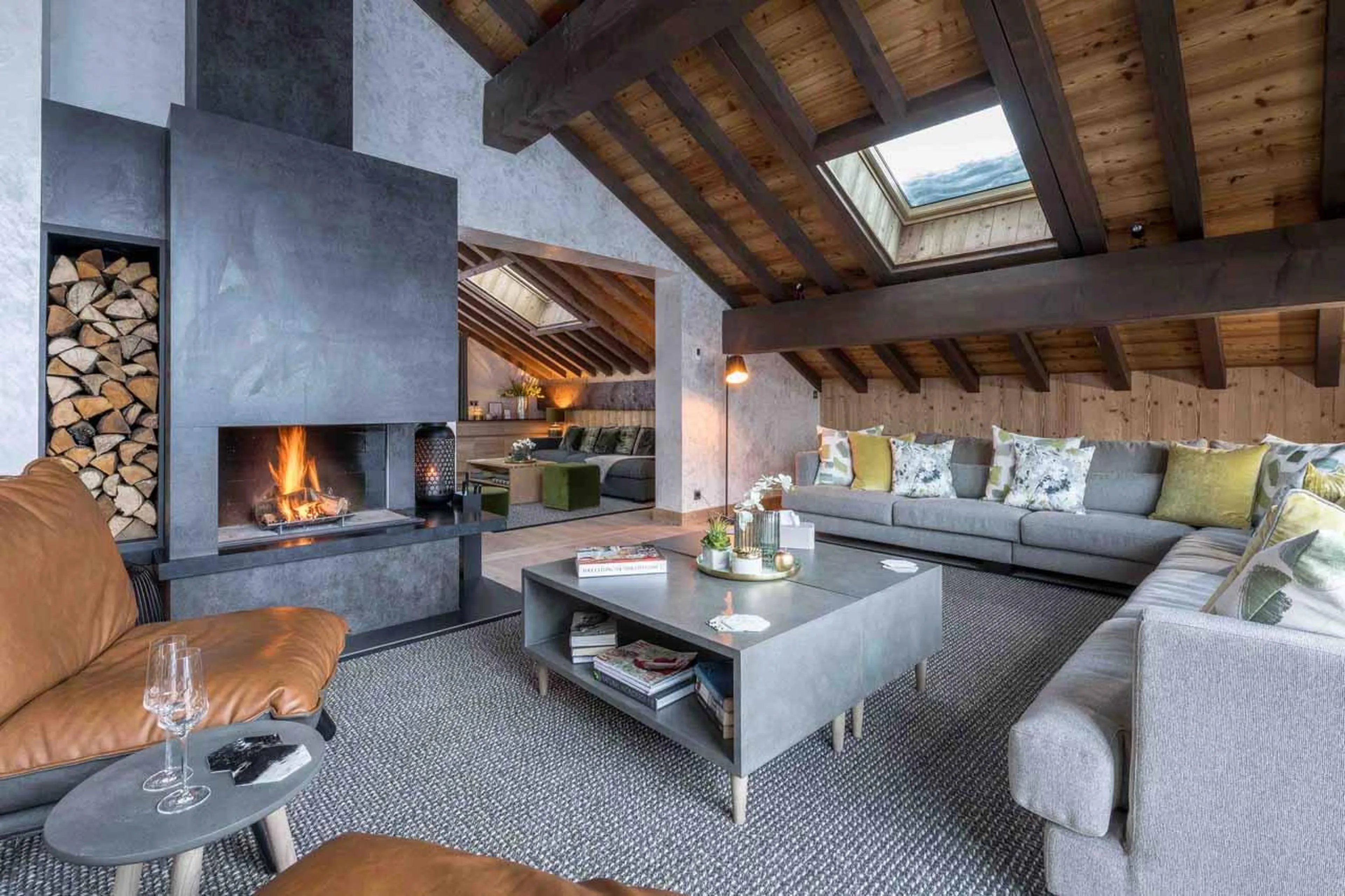 Fireplace, coffee table and wrap-around sofa in Chalet Serendipity, Meribel