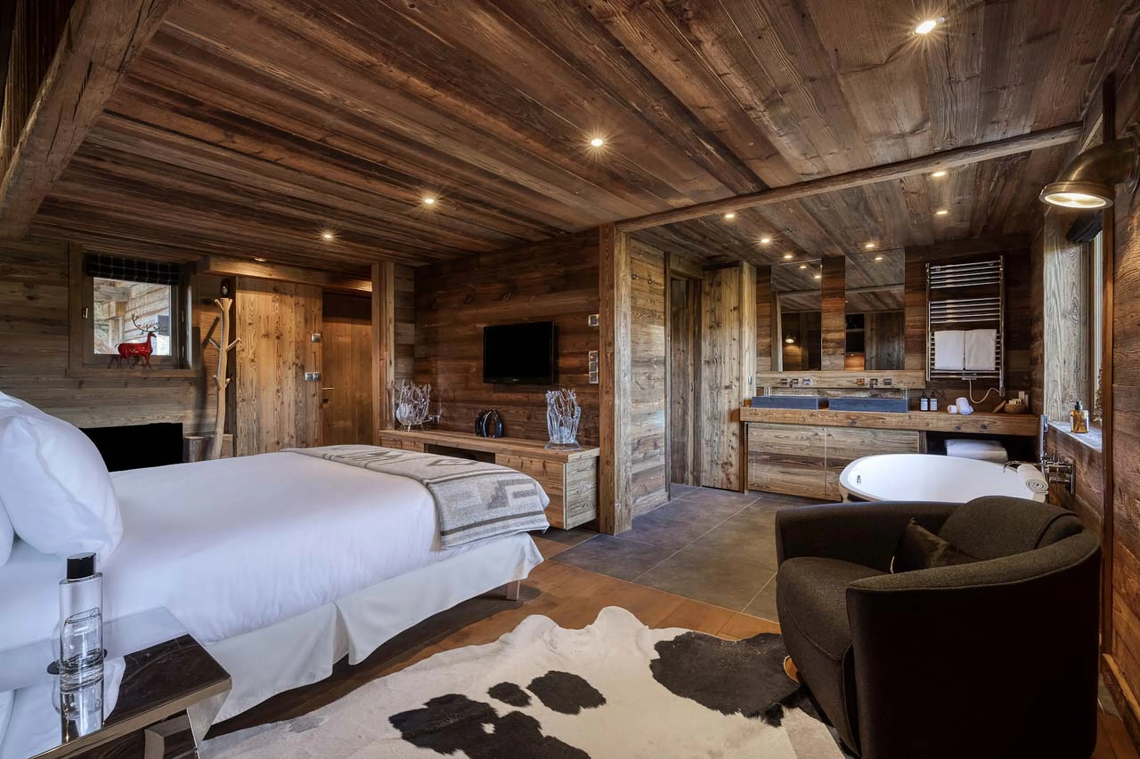 Bedroom with open bathroom at Chalet Talland in Megeve