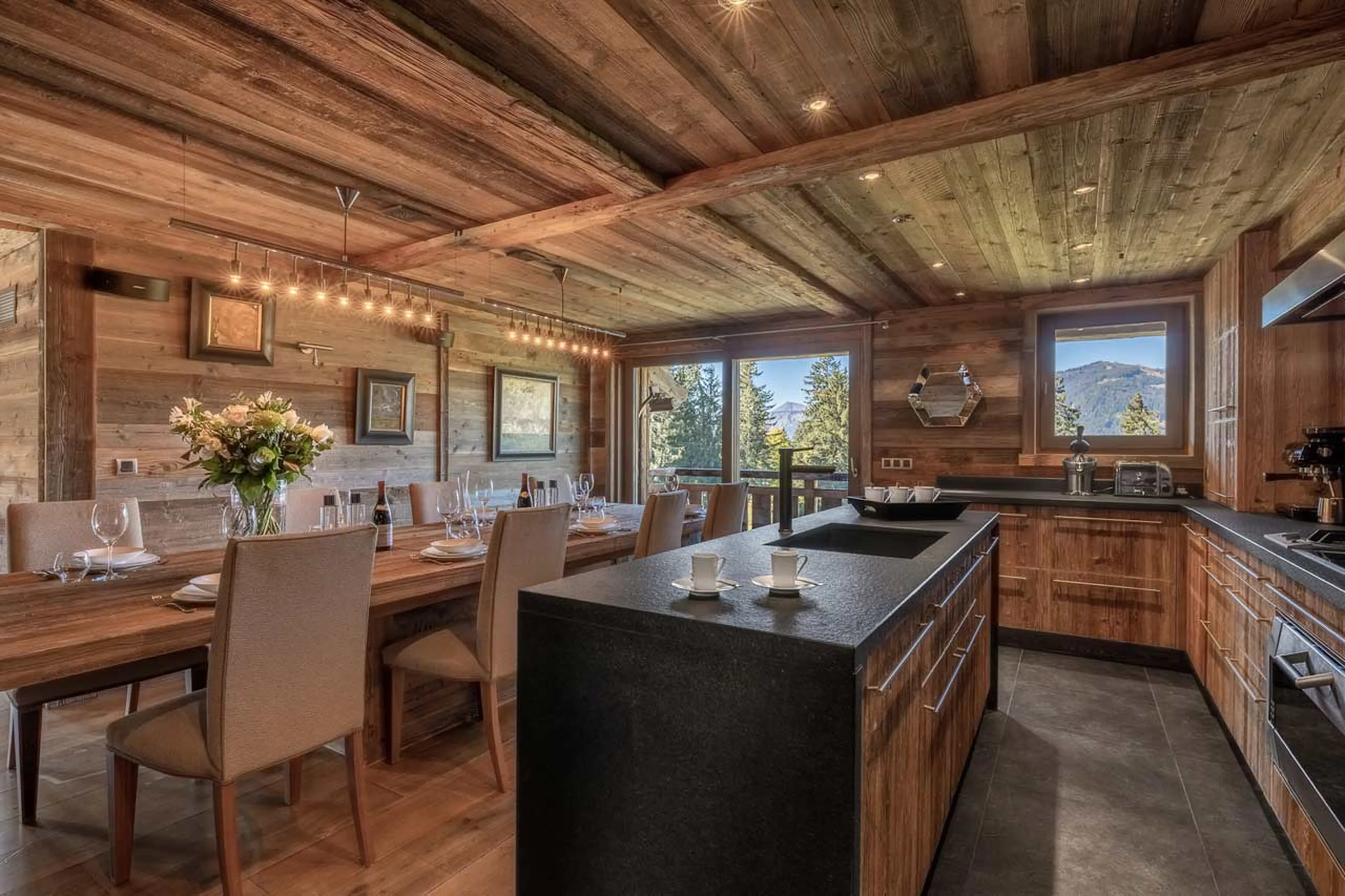 Dining table and kitchen at Chalet Talland in Megeve
