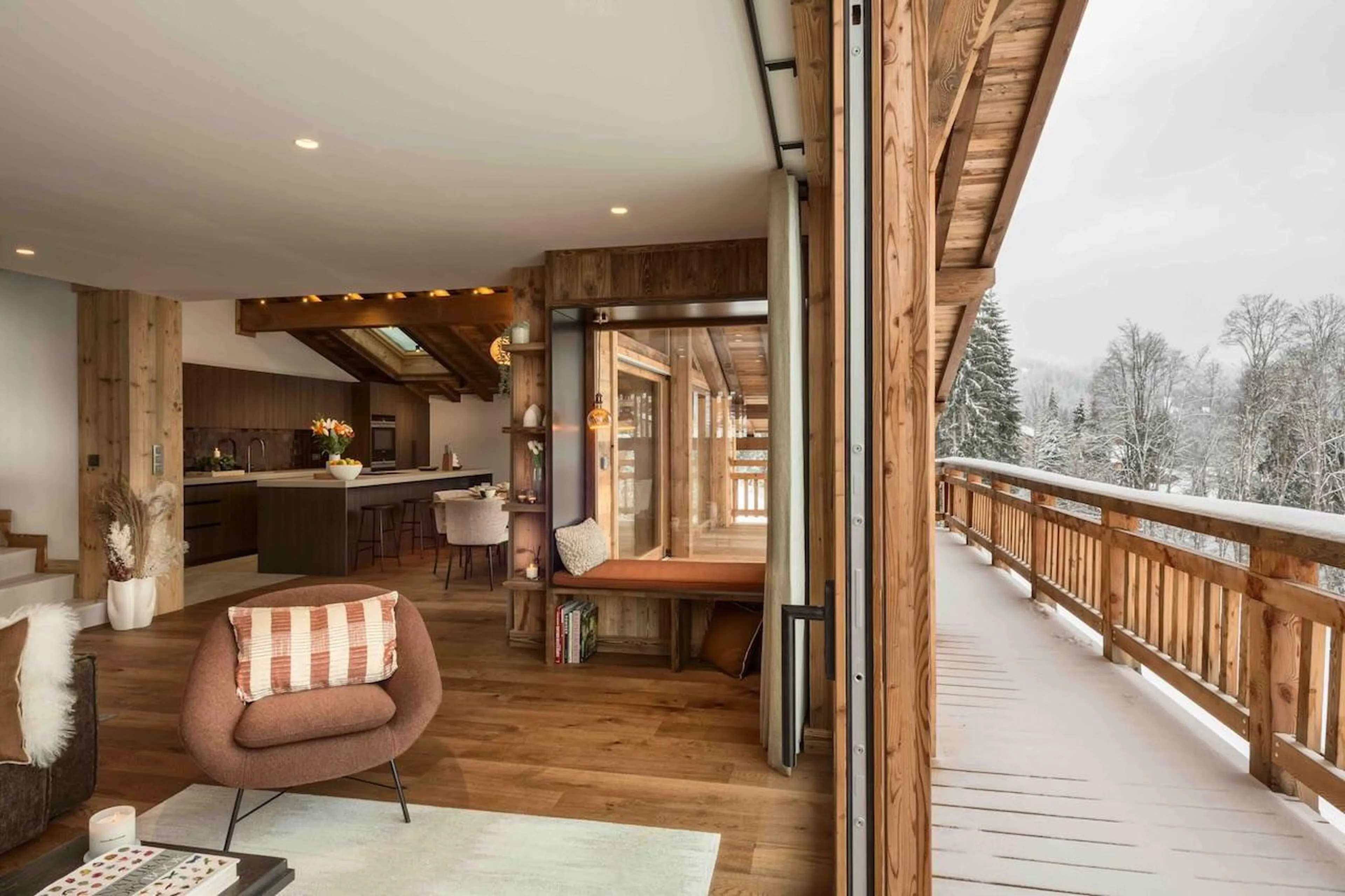Open-plan living room with access to beautiful balcony space at Chalet Tosca in Les Gets