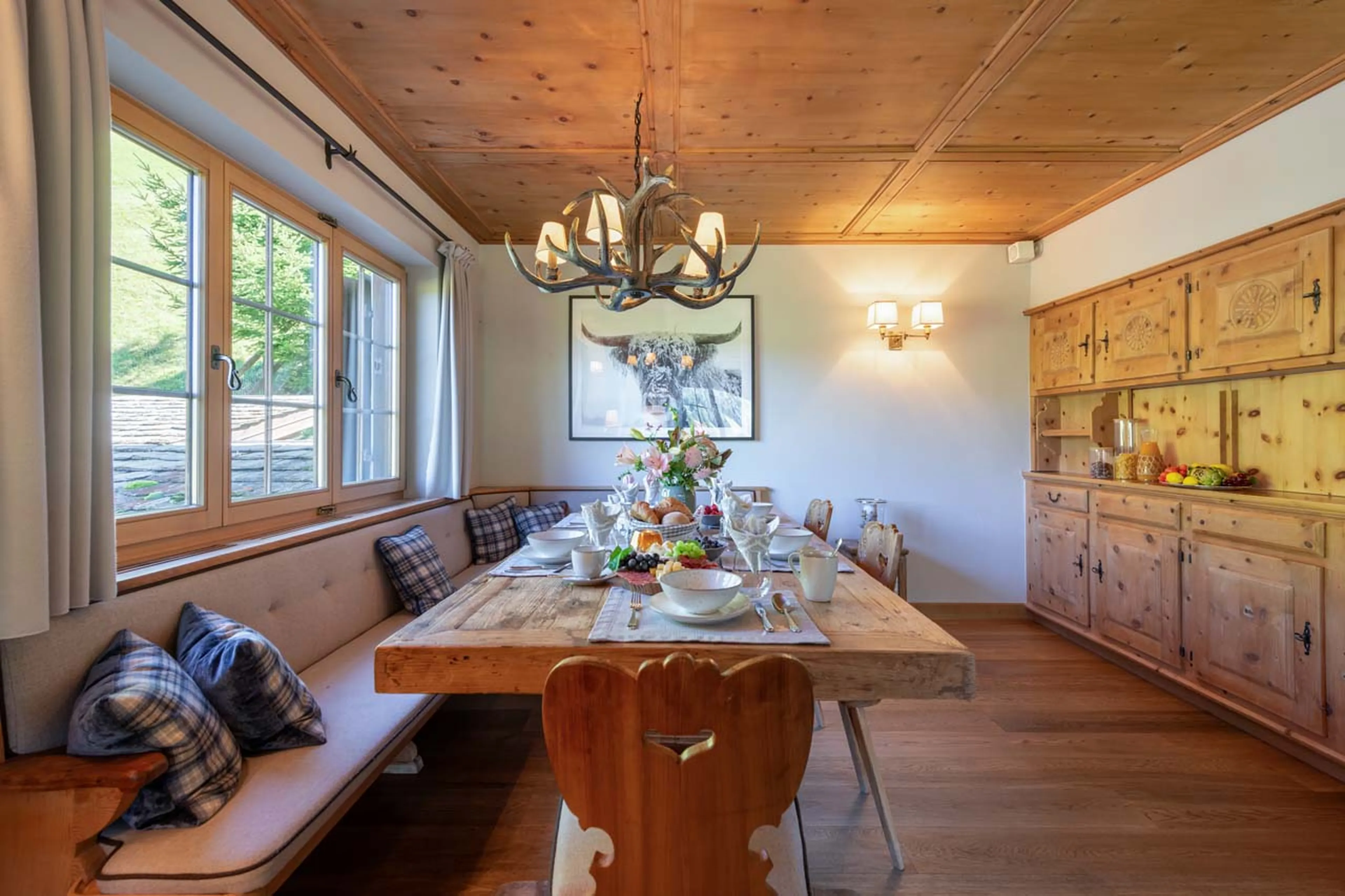 Dining table with bench style seating at Chalet Tschuetta in Klosters