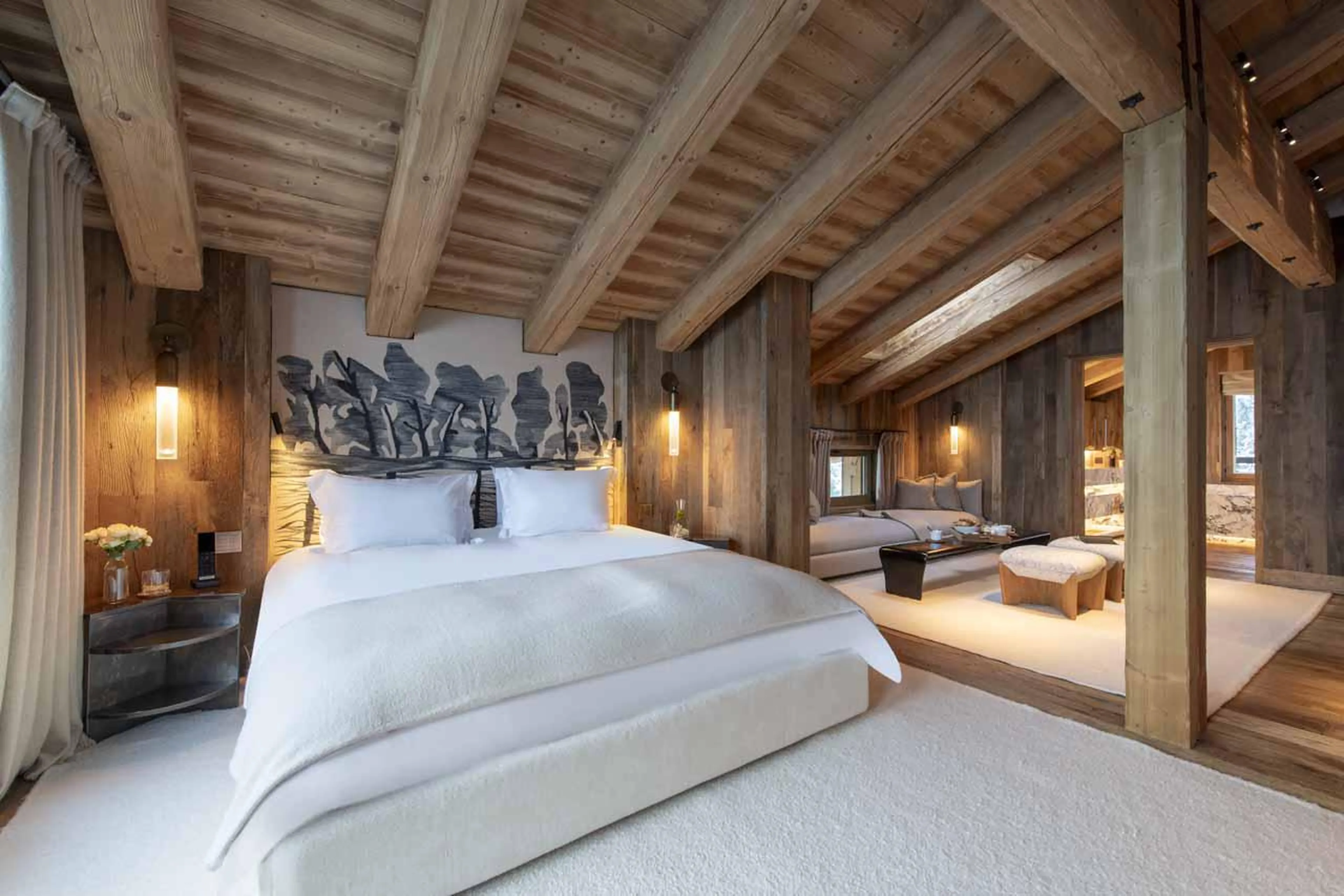 Top floor master bedroom with wooden-beamed ceiling at Chalet Vicuna in Verbier