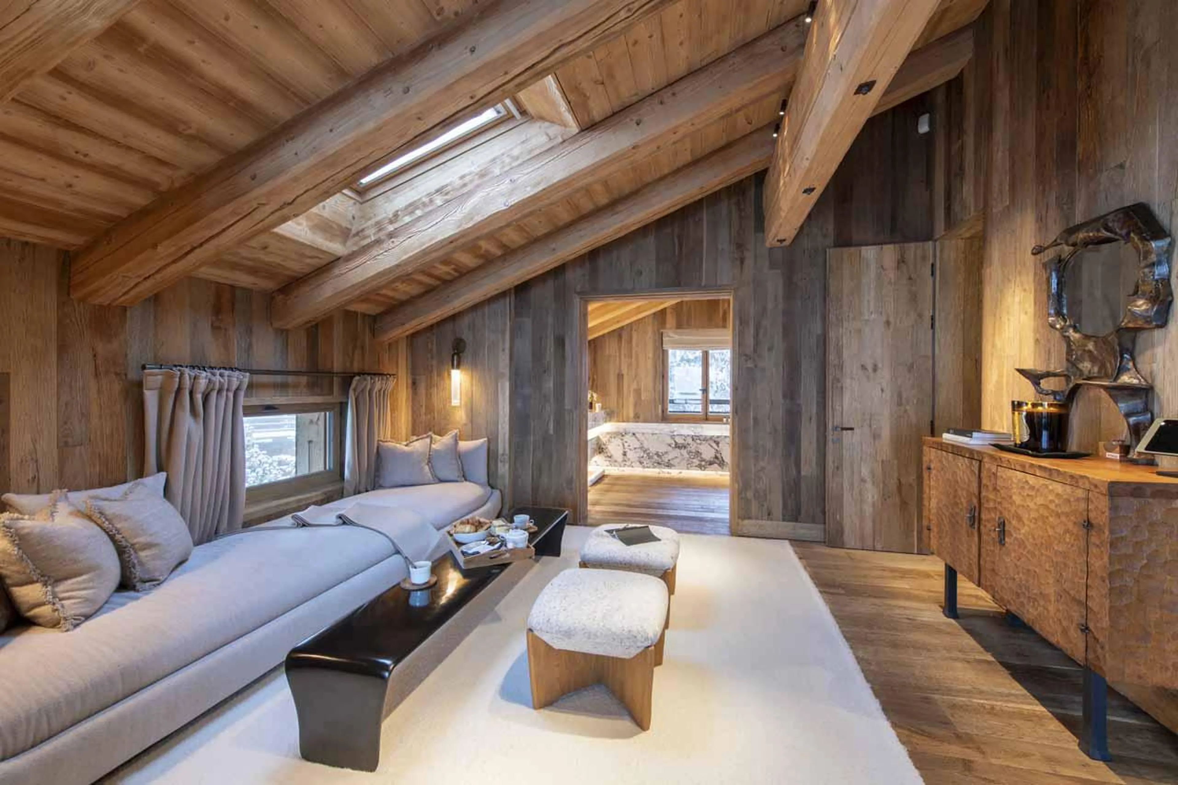 Sofa area within top floor master bedroom at Chalet Vicuna in Verbier