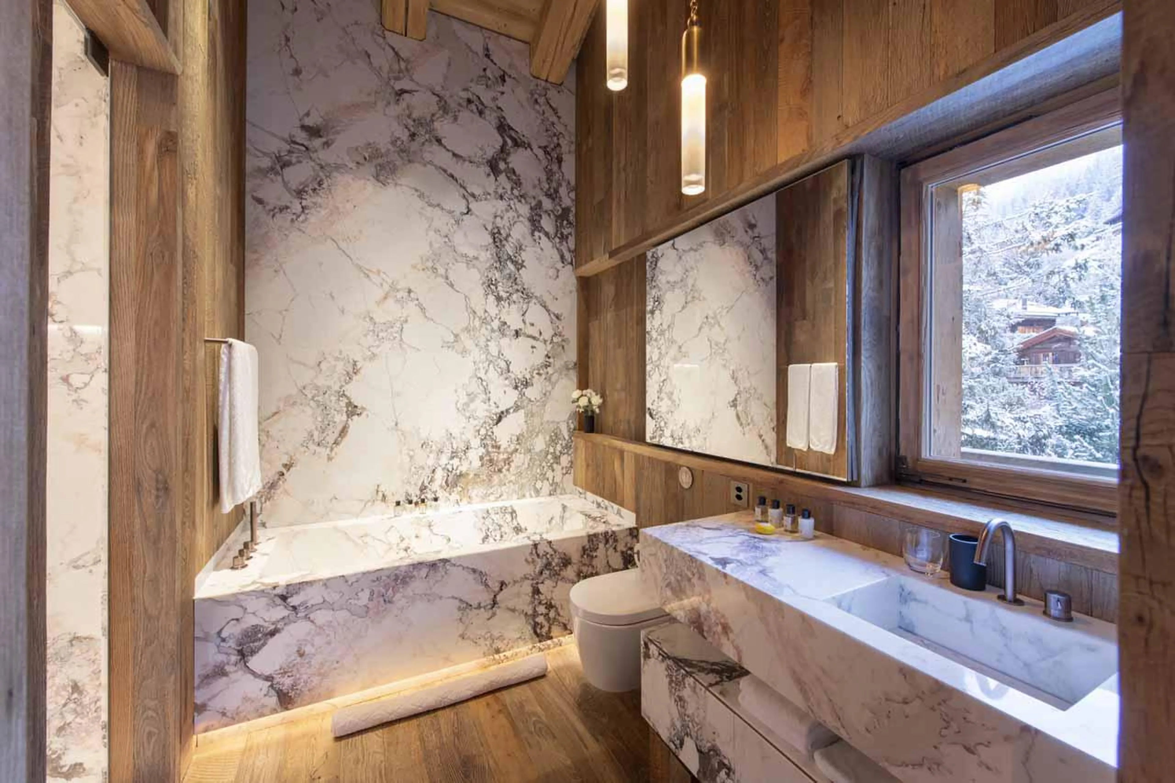 Double en-suite bedroom with bath and shower at Chalet Vicuna in Verbier