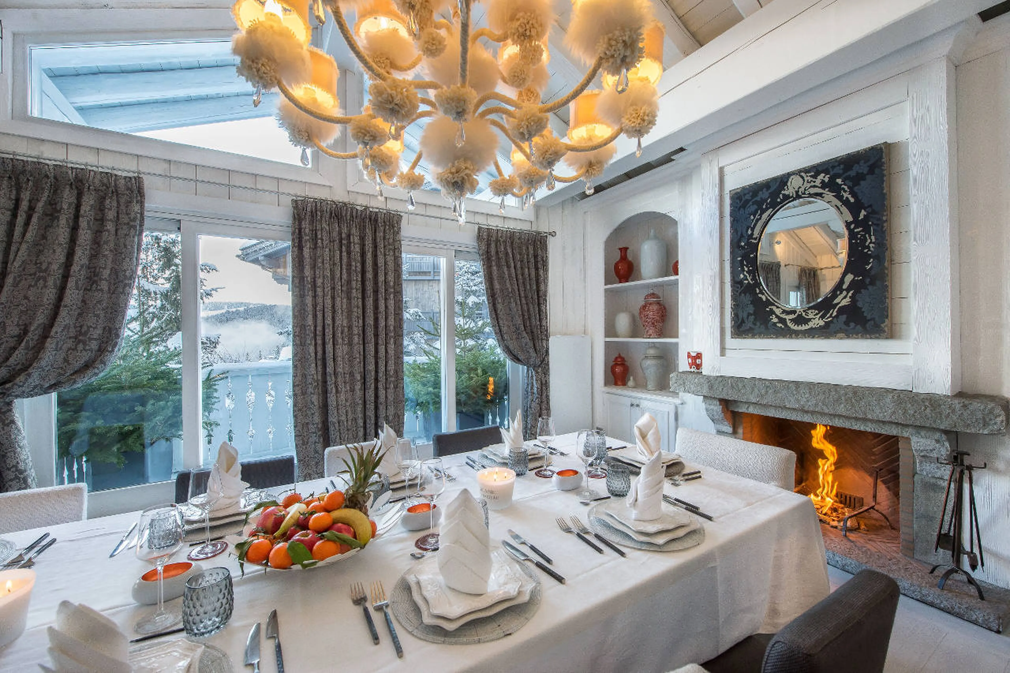 Dining room with fireplace and balcony access in Chalet White Dream, Courchevel 1850