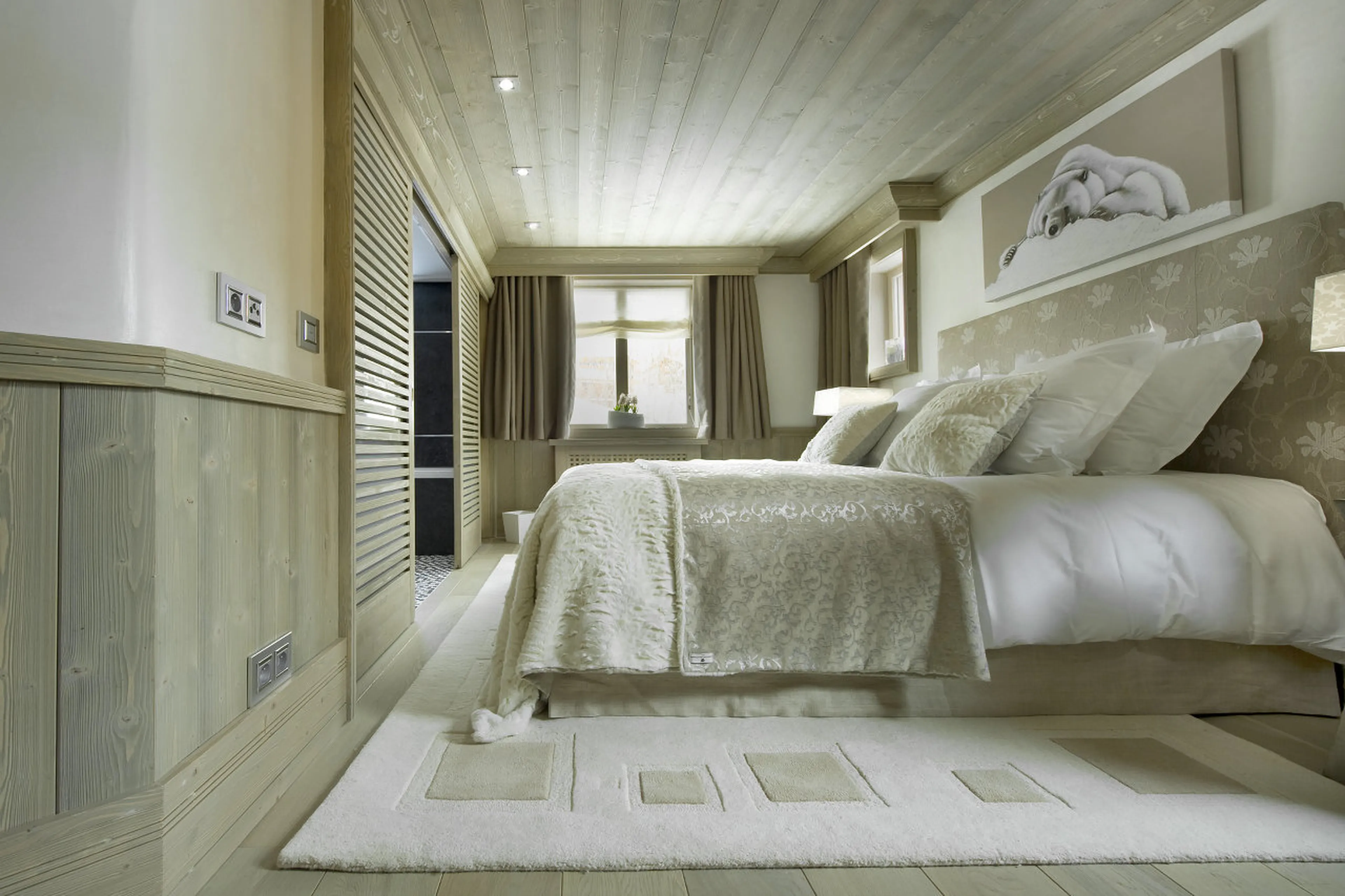 Bedroom with double bed and balcony access in Chalet White Pearl in Val d’Isere