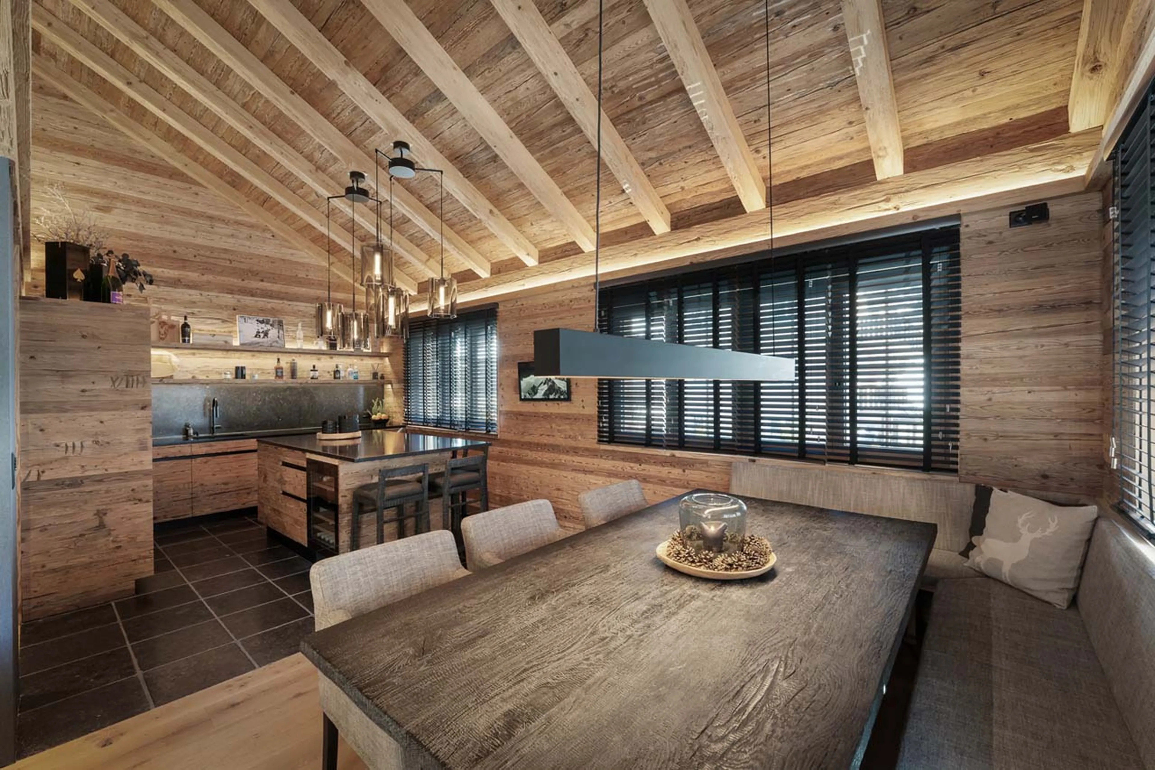 Dining table and kitchen in Chalet Wood, Davos