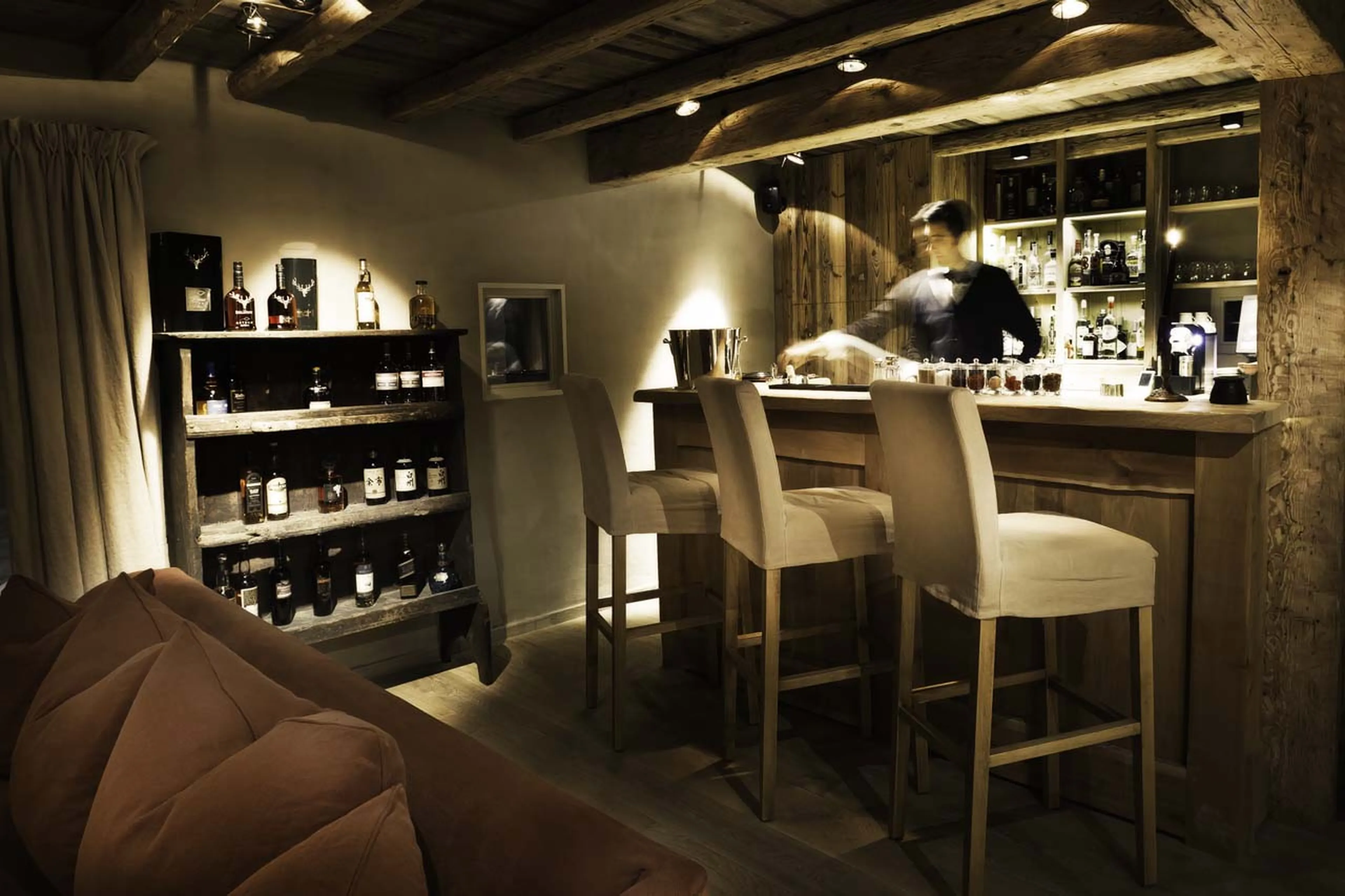 Barman in lounge bar of Le Chalet Zannier in Megeve