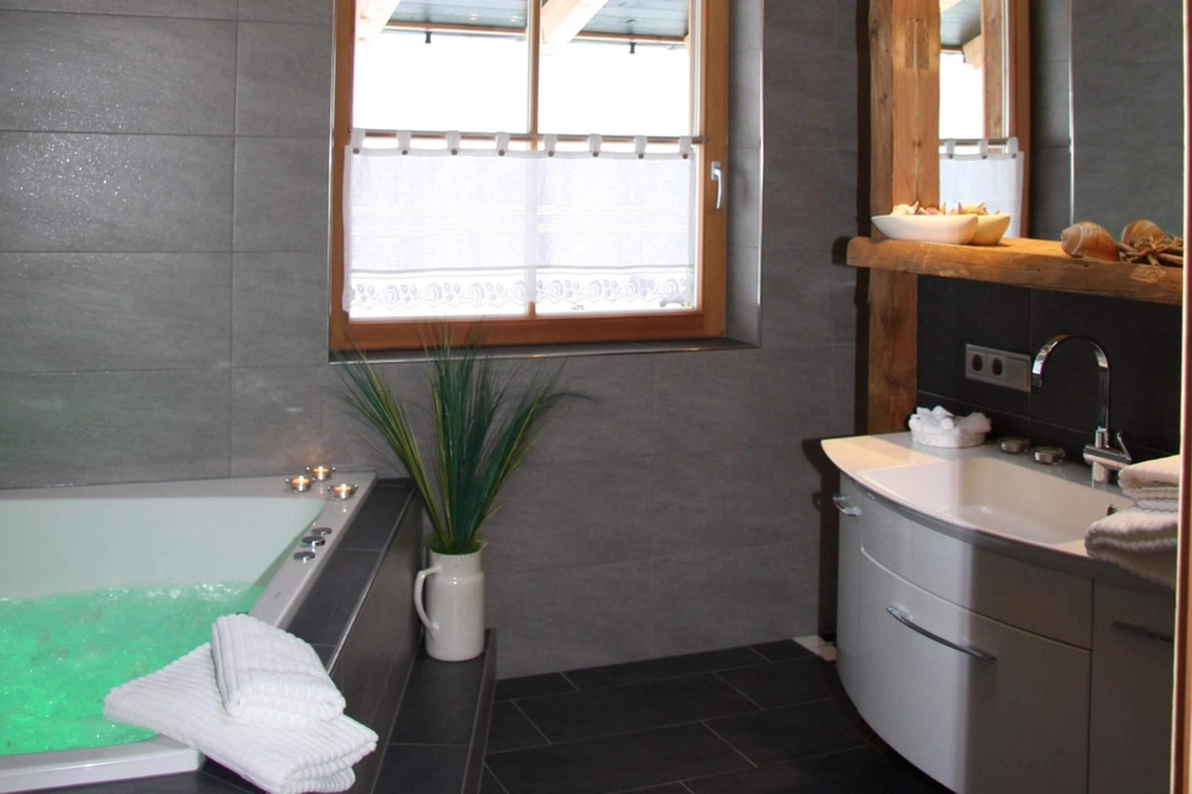 En-suite bathroom with Jacuzzi bath in Chalet Ziller in Zillertal